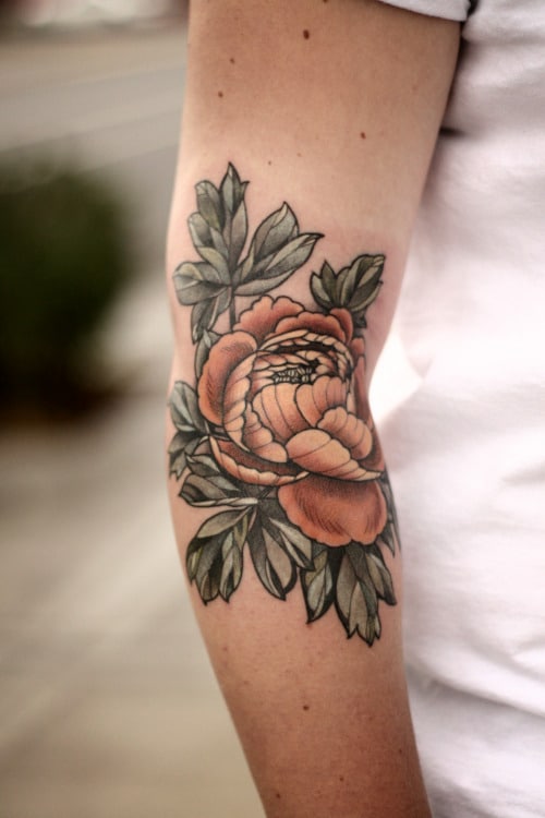 Black and grey rose tattoo on the inner elbow