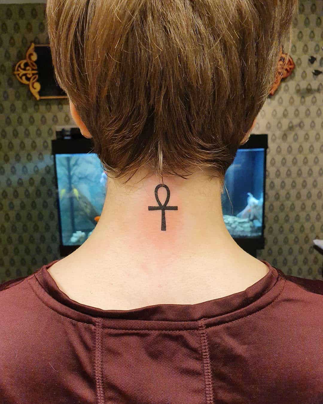 Small Black Ankh Tattoo On Front Shoulder