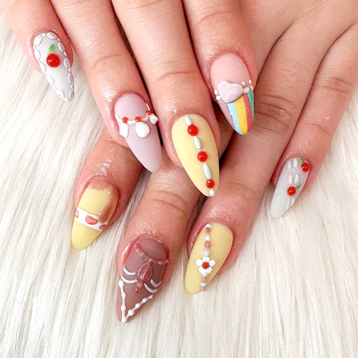 Adorable Almond and Stiletto Birthday Cake Nails in Pastel Colors with Playful Patterns and Sweet Motifs