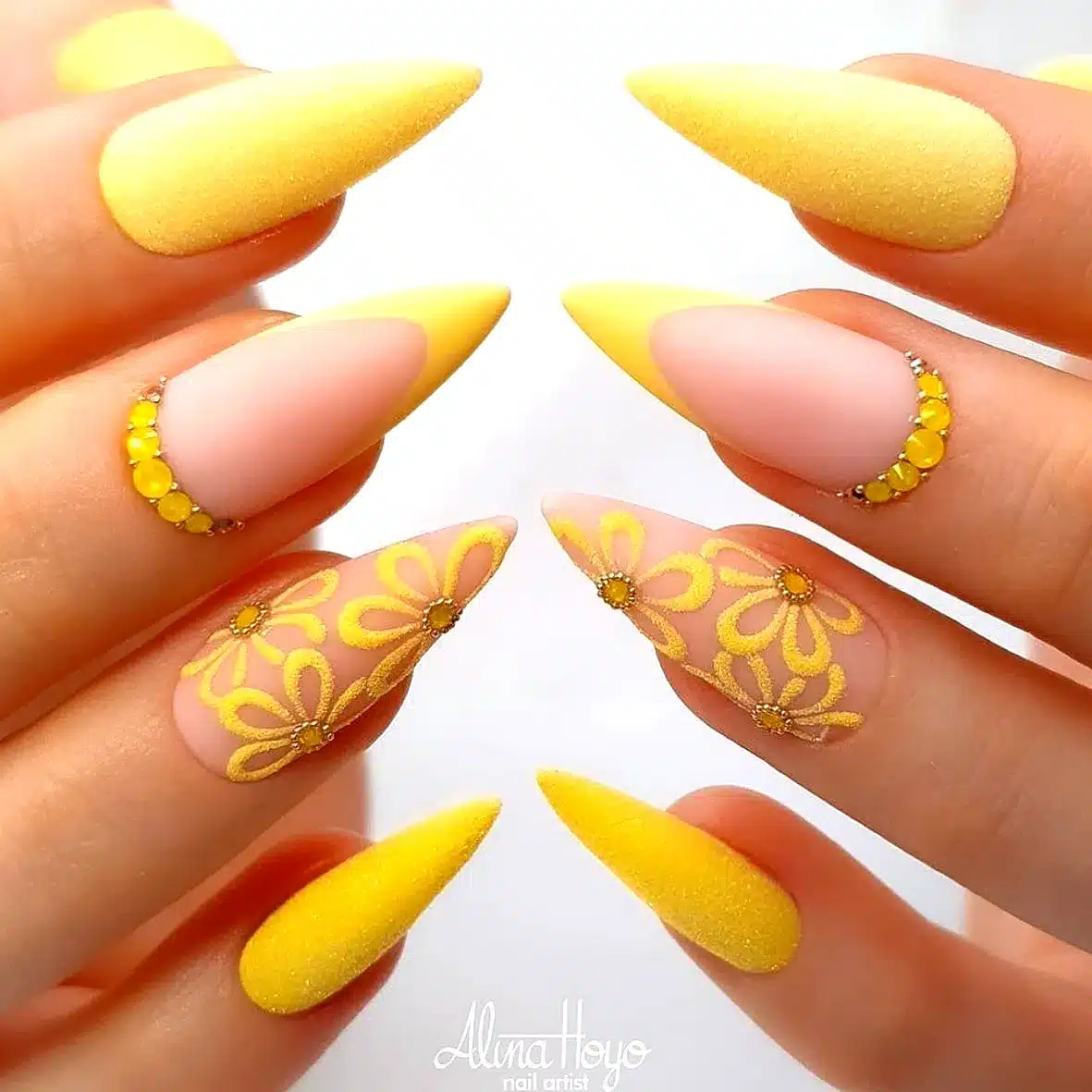 Adorable Almond-Shaped Sunflower Nail Designs in Pastel Yellow and Nude with Floral Accents and Gem Embellishments