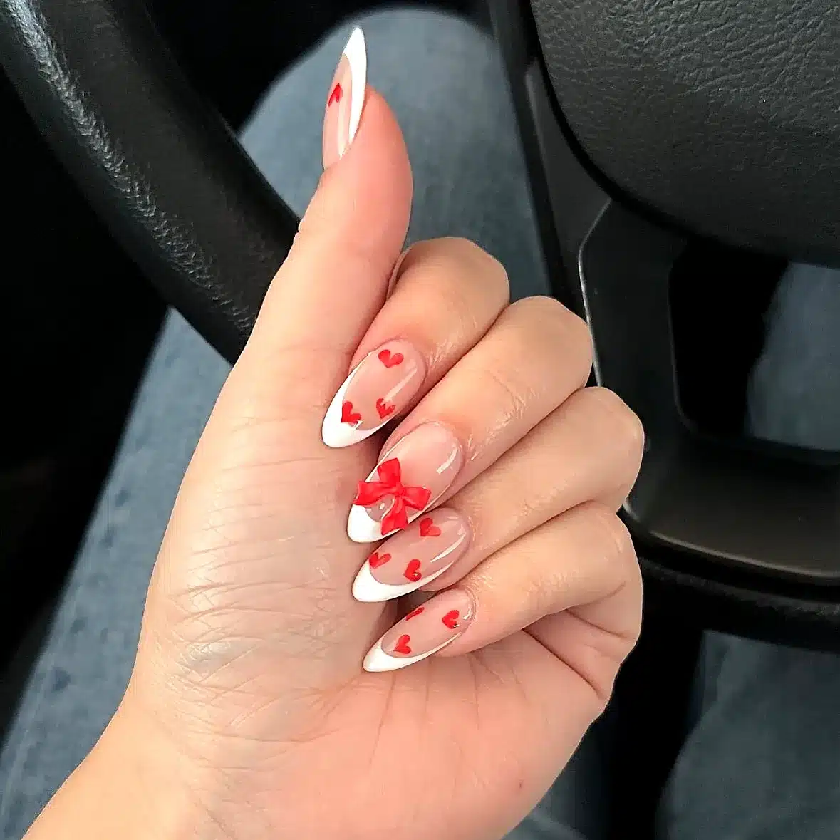 Adorable Almond Shaped Valentines Day Nails with Nude Base White Tips and Red Hearts