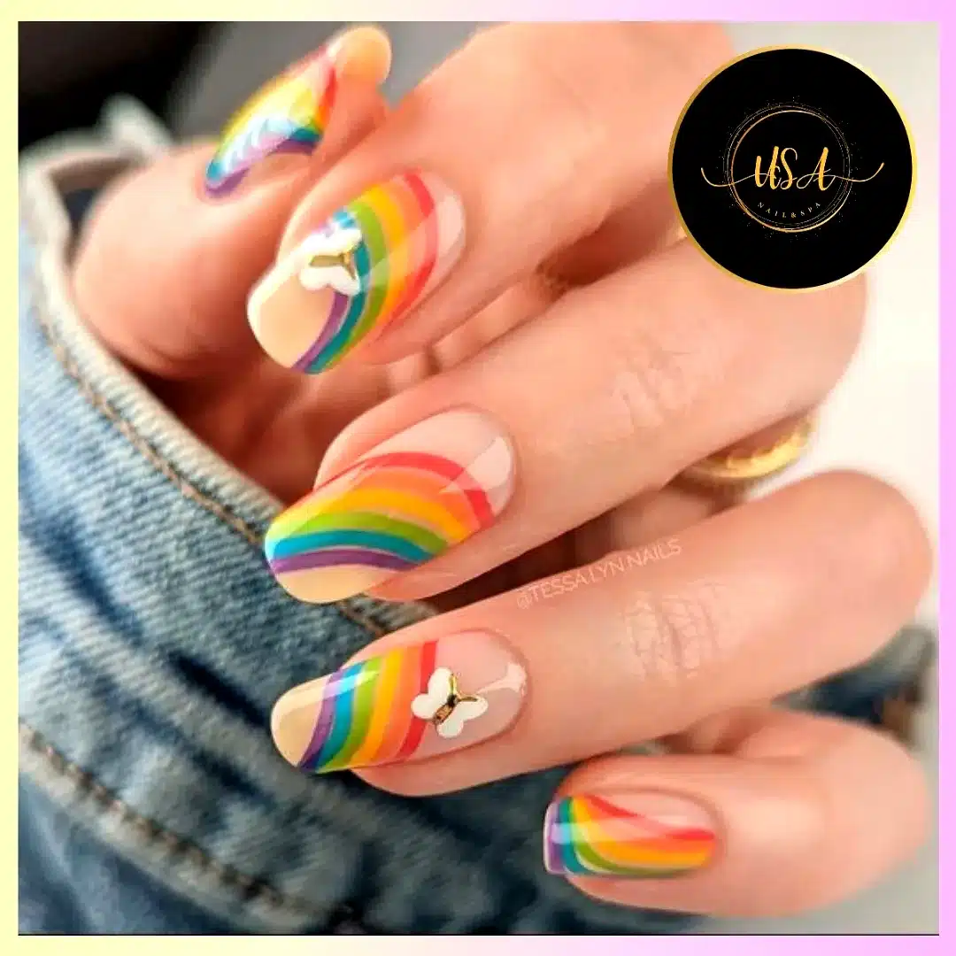 Adorable natural rainbow nail designs with glossy finish and whimsical butterfly accents
