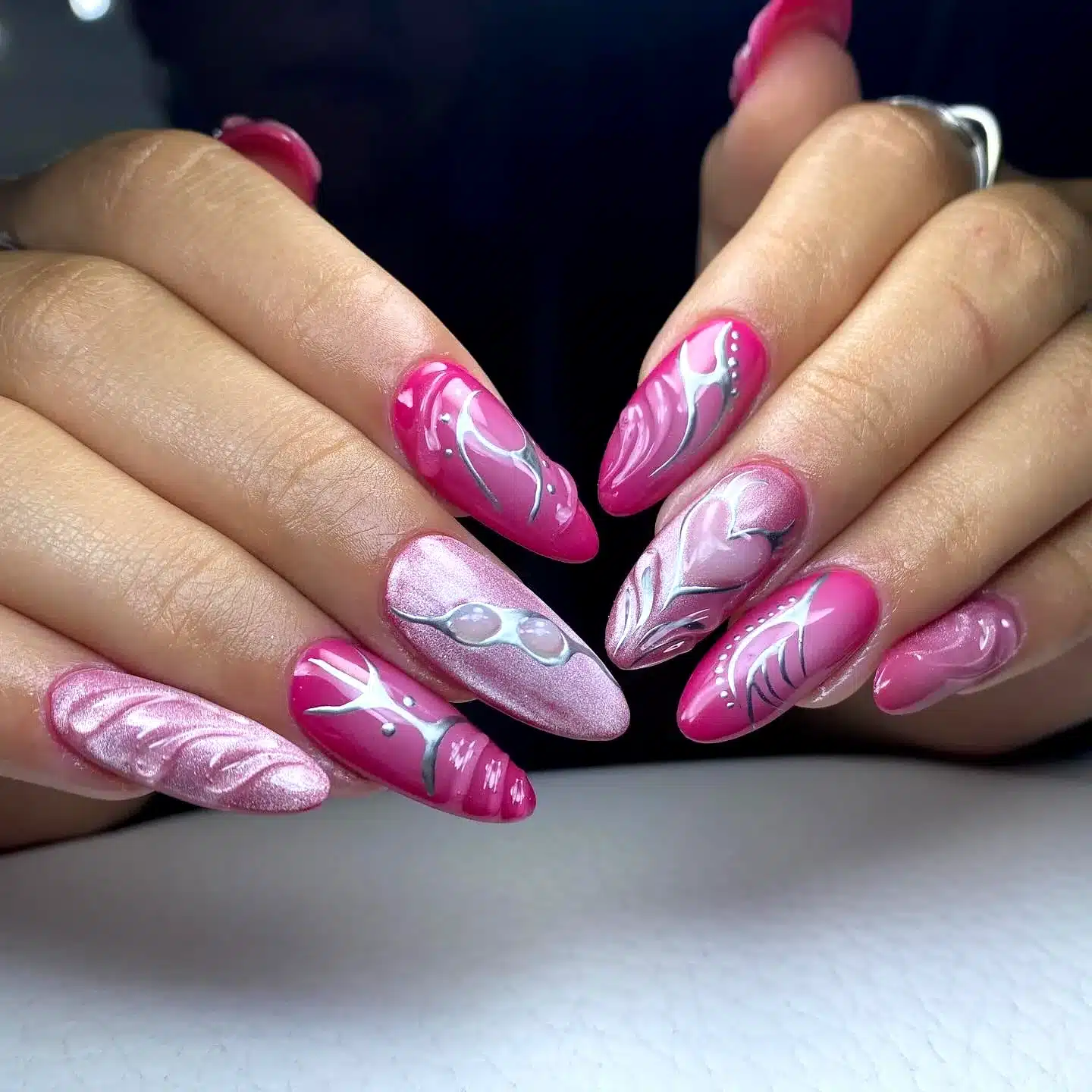 Adorable Stiletto Pink Birthday Nails with Glossy White and Silver Swirling Designs