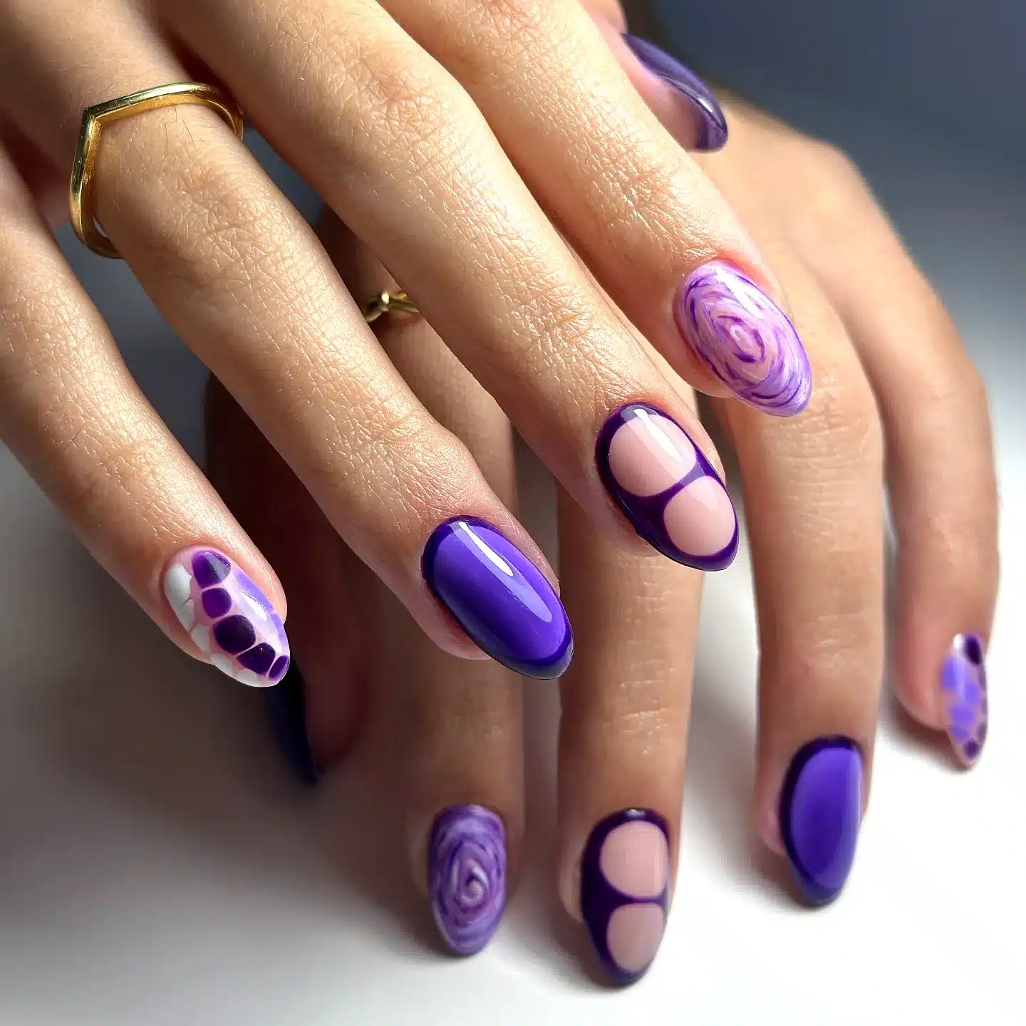 Artistic Almond-Shaped Purple Nails with Swirls Polka Dots and Negative Space Elements