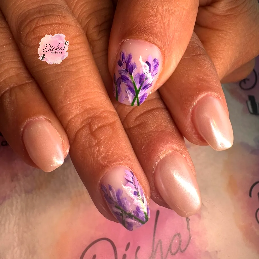 Beautiful oval lavender flower nails with a soft nude base and glossy accents
