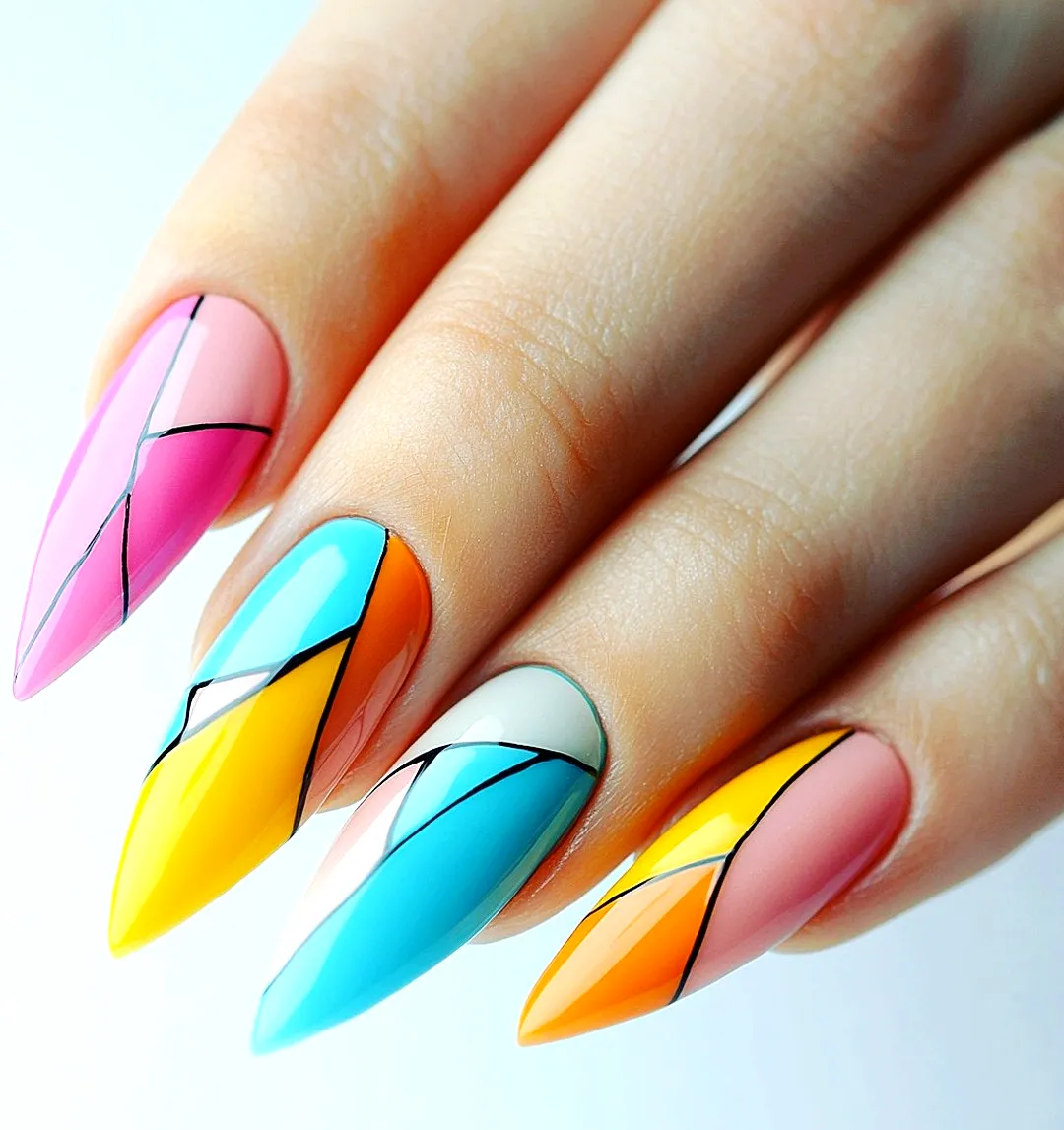 Bold Geometric Nail Designs in Stiletto Shape with Vibrant Colors and Sharp Angular Lines