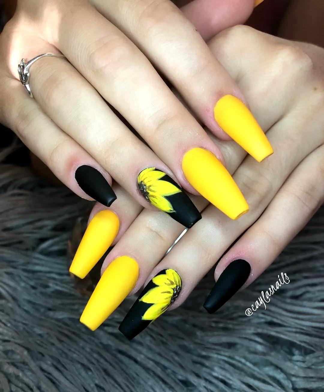Bold Stiletto Sunflower Nail Designs with Vibrant Yellow and Matte Black Art