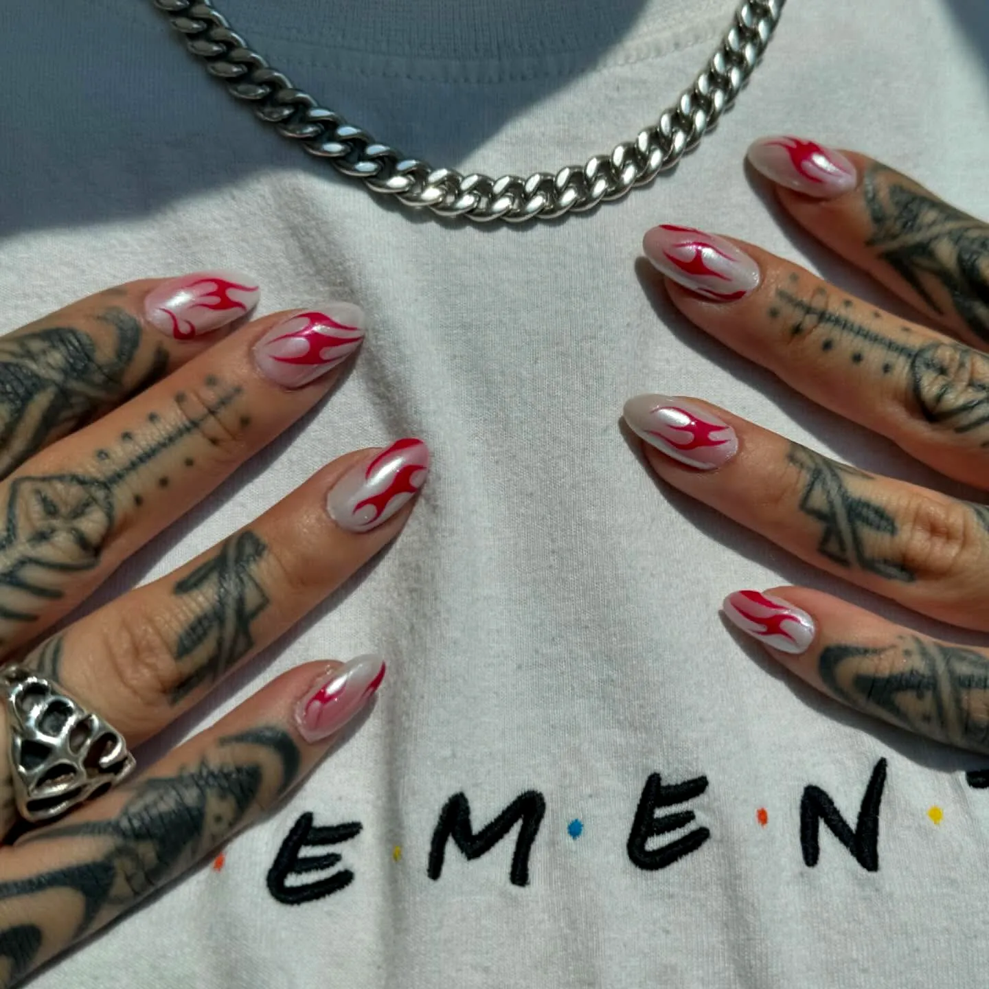 Bold Tribal Nails with Pointed and Almond Shapes in White and Pink Accented by Red Flame Patterns