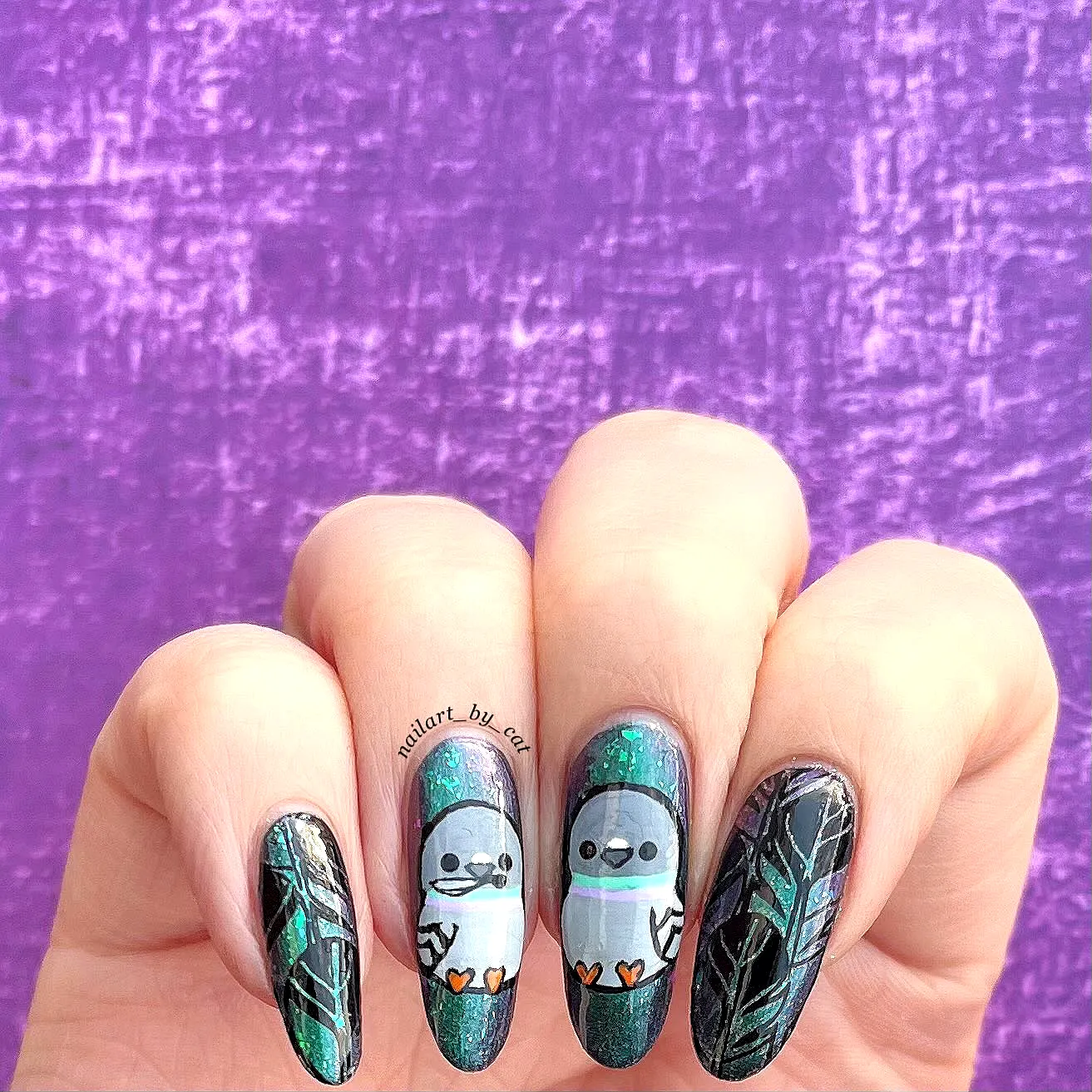 Charming Almond Bird Nail Designs with Glittery Dark Green and Black Colors Featuring Sloth Illustrations and Leaf Patterns