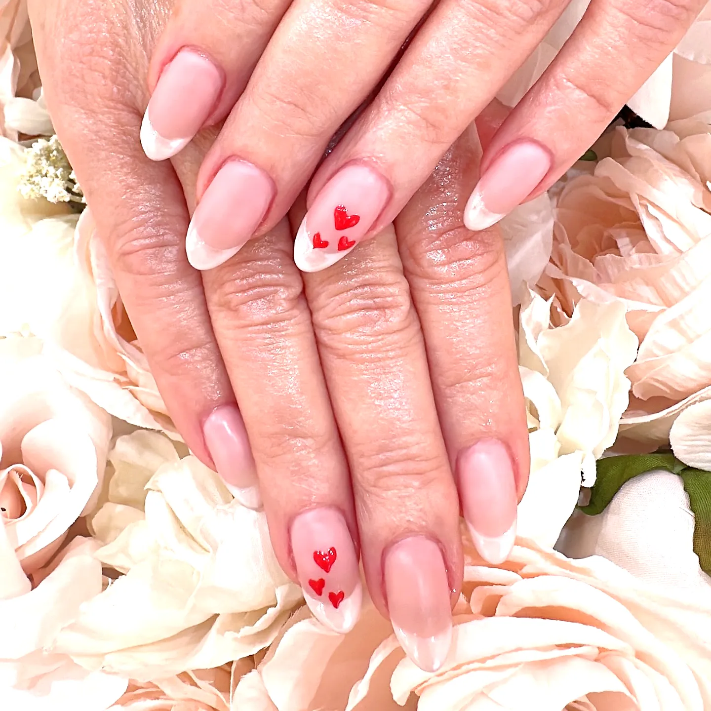 Charming Almond Shaped French Manicure with Soft Pink and White Tips Featuring Ring Finger Heart Nails