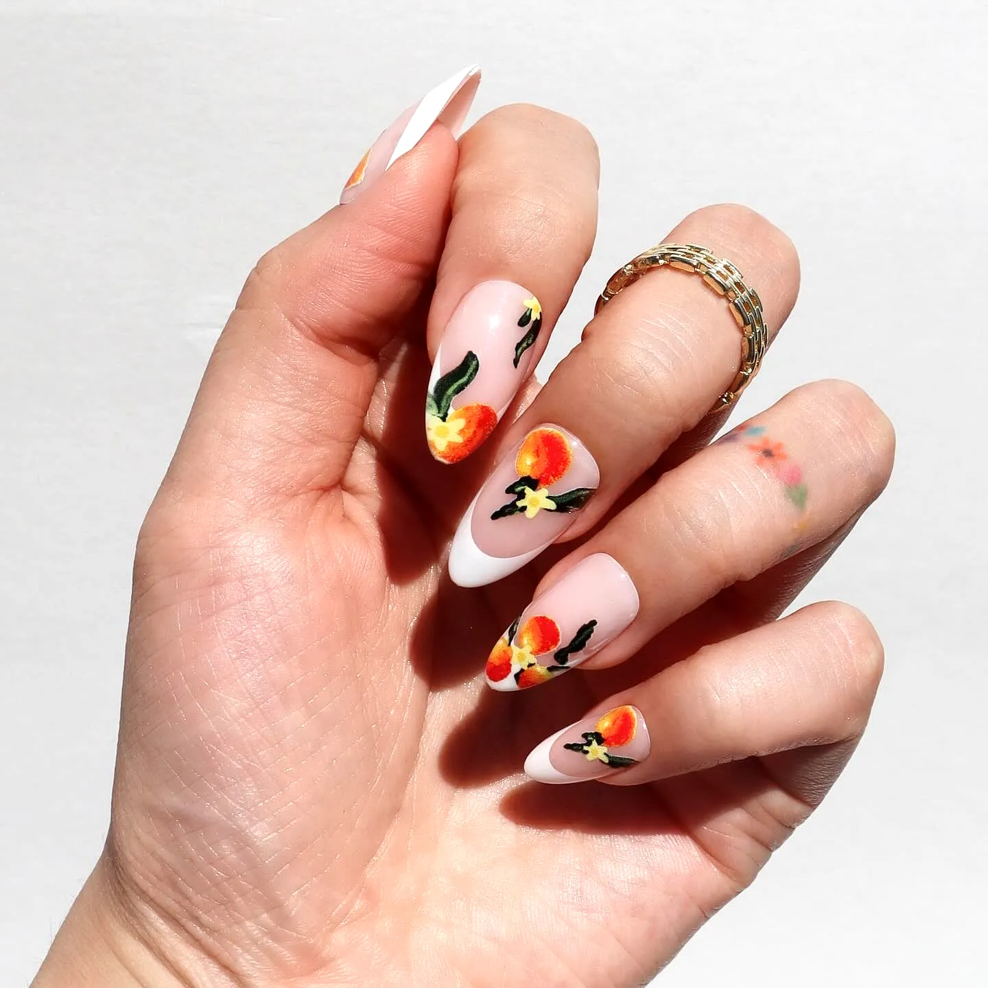 Charming Almond Shaped Fruit Nail Designs with Light Nude Base Floral Motifs and White French Tips