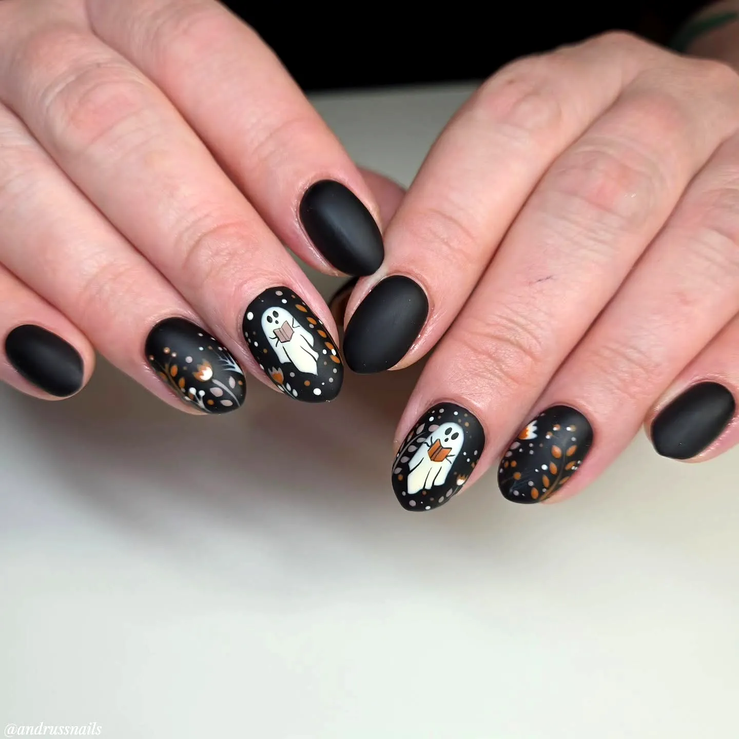 Charming Almond Shaped Ghost Nail Designs with Matte Black Finish and Whimsical Illustrations