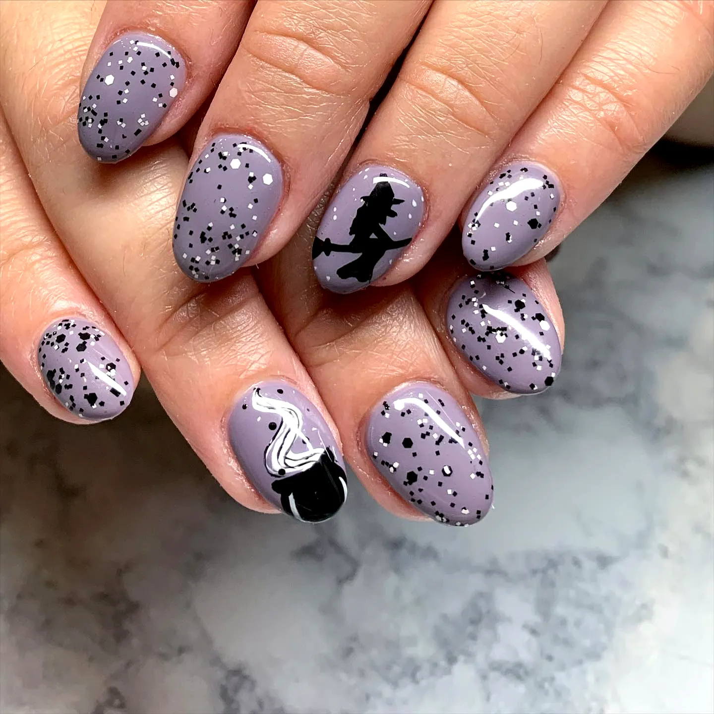 Charming Almond-Shaped Lavender Silhouette Nail Designs with Whimsical Witch and Marbled Accents