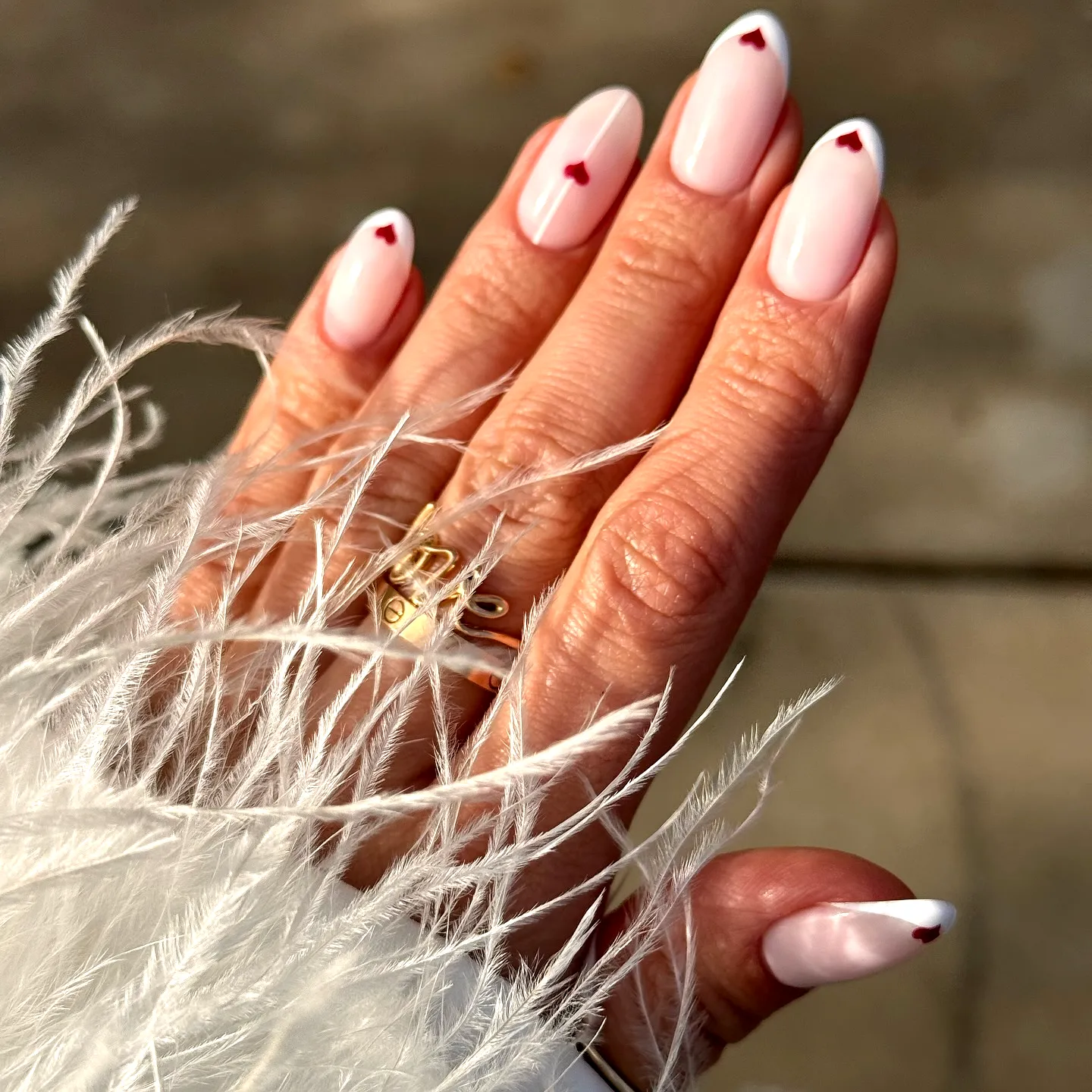 Charming Almond Shaped Light Pink and White Ring Finger Heart Nails with Delicate Red Accents