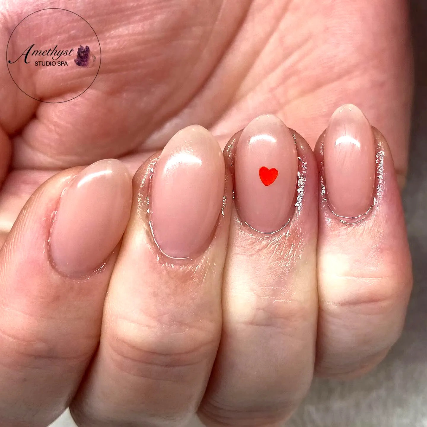 Charming Almond Shaped Nude Glossy Ring Finger Heart Nails with Minimalist Red Heart Art