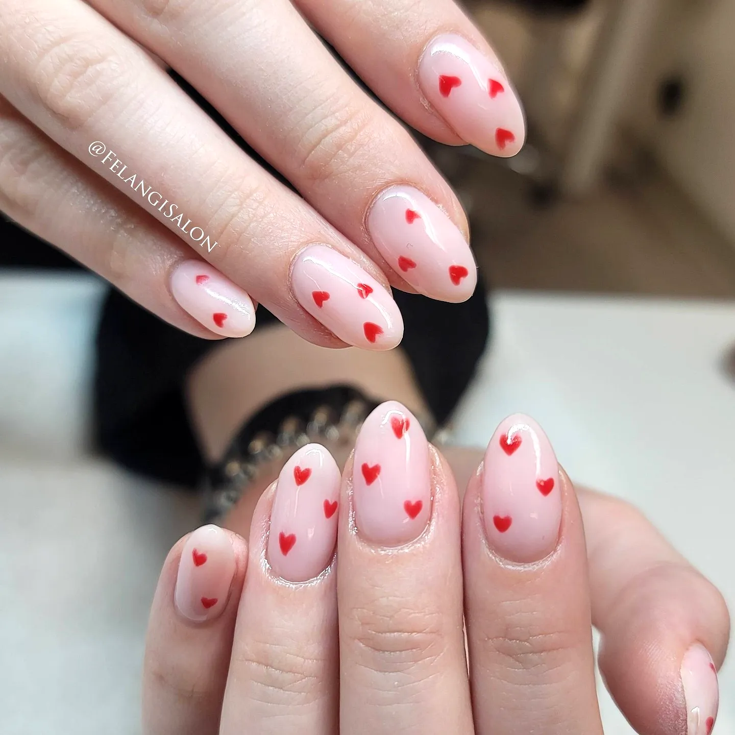 Charming Almond-Shaped Pink Heart Nails with a Soft Nude Pink Base and Playful Red Heart Design