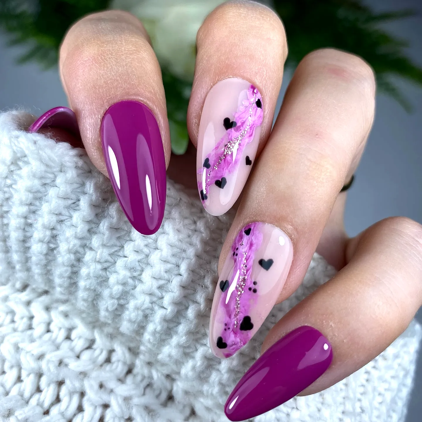 Charming Almond-Shaped Purple Nails with Delicate Pink Swirls and Glitter Accents