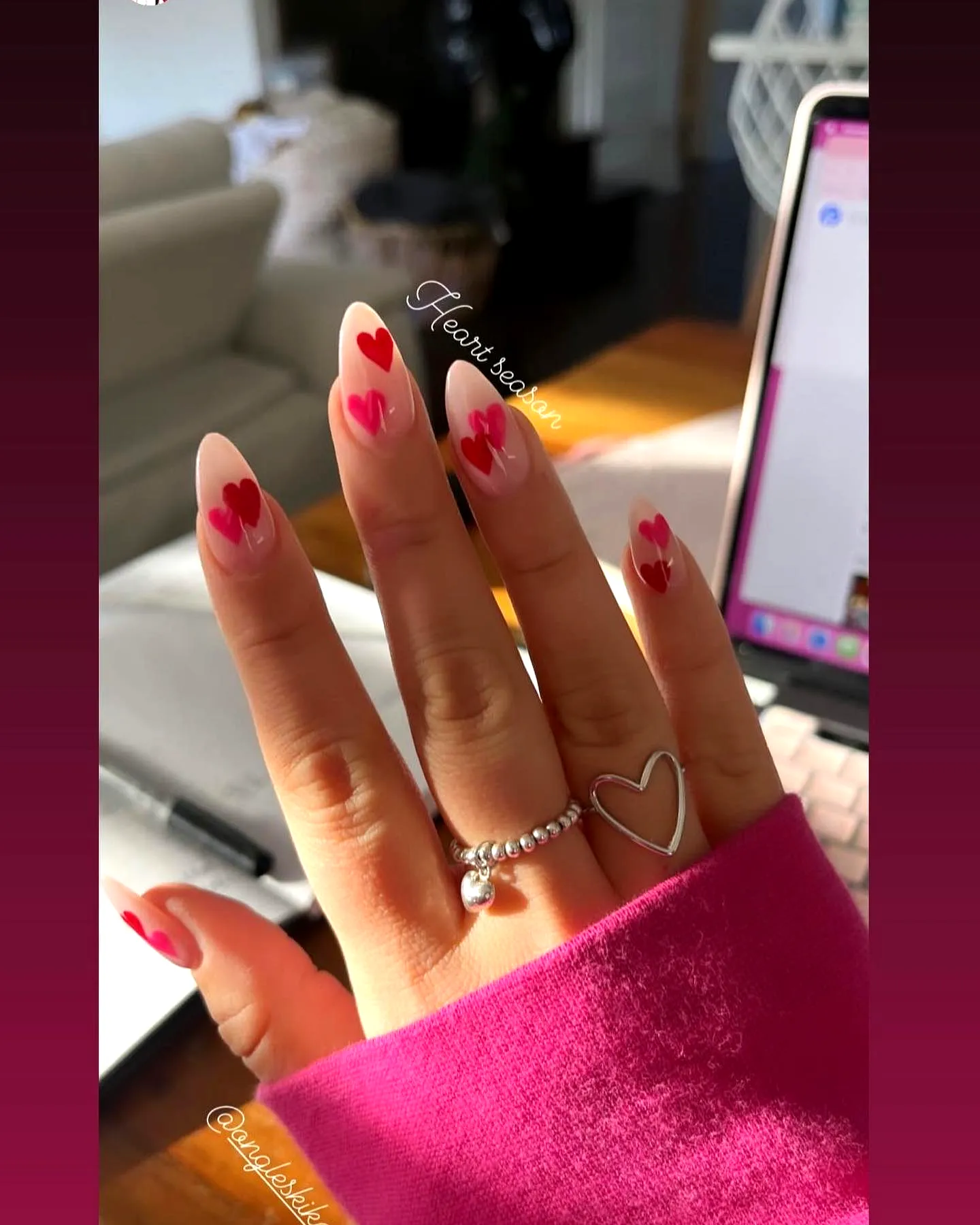 Charming Almond Shaped Ring Finger Heart Nails with Vibrant Red Patterns on a Nude Base