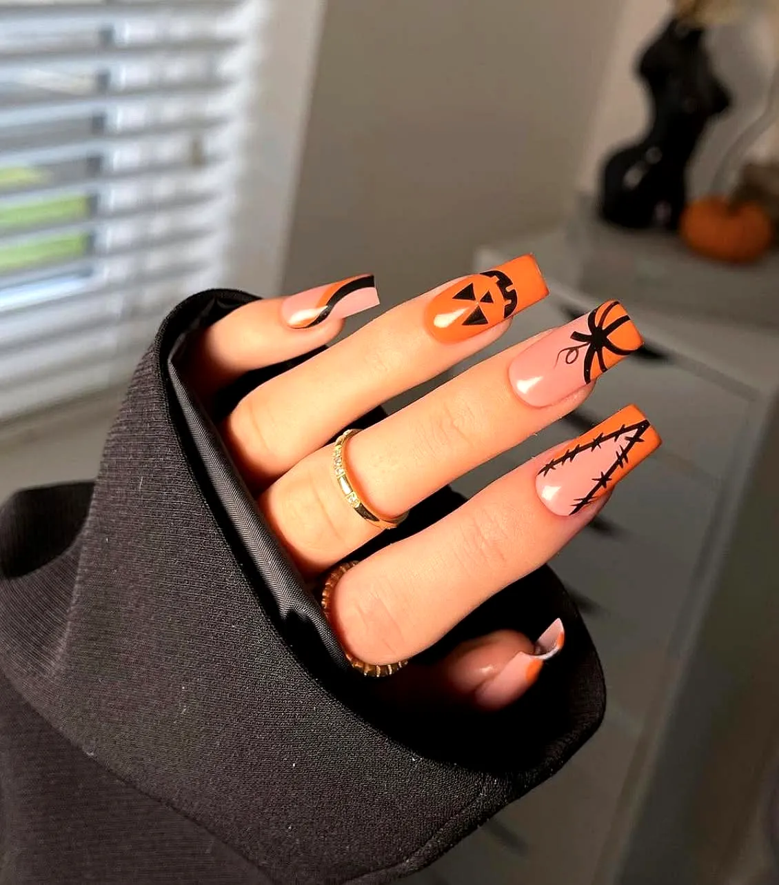 Charming Ghost Nail Designs with Long Rectangular Nails in Orange and Black Featuring Pumpkins Spider Webs and Intricate Line Art