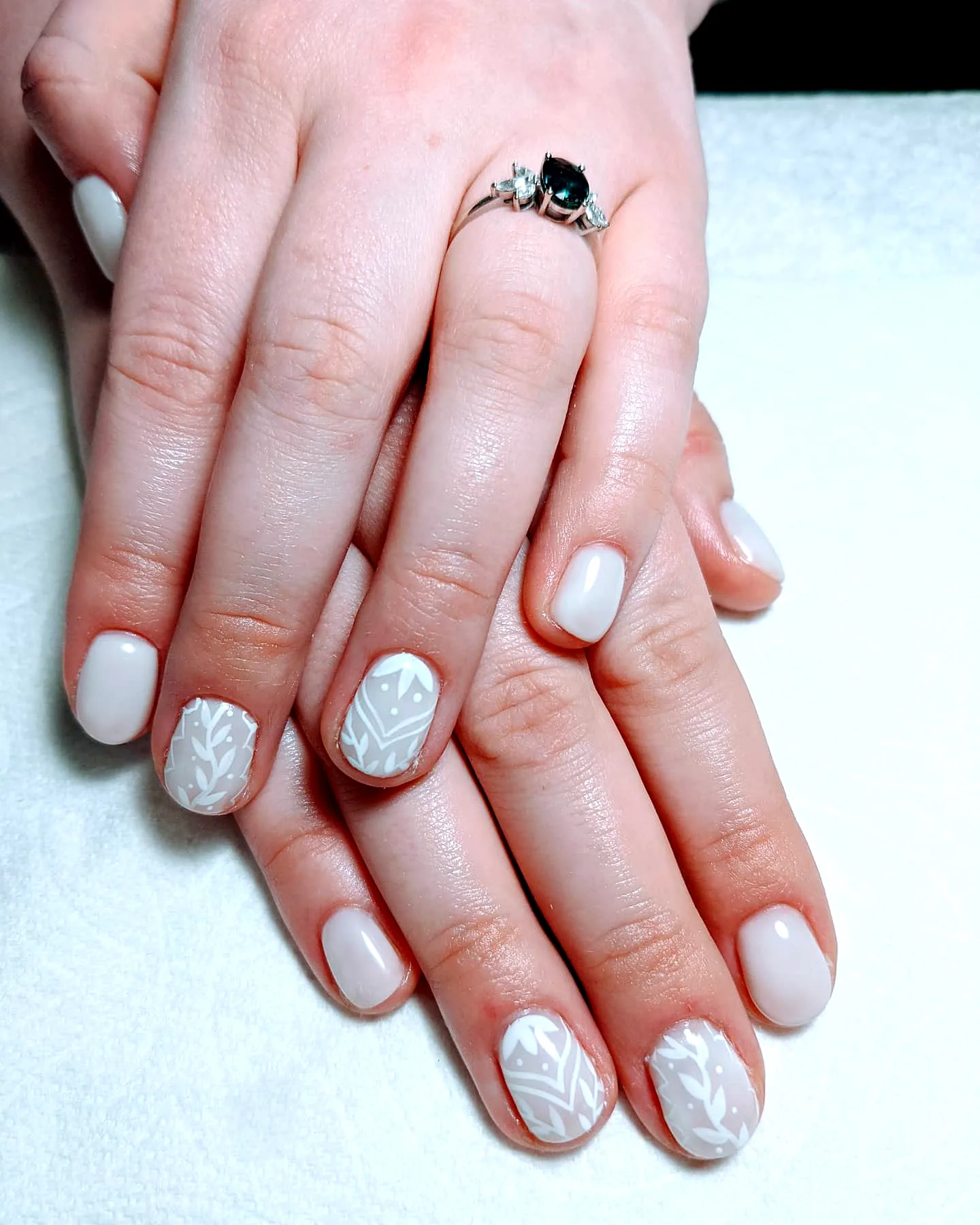 Charming Gothic Easter Nails with Soft White Color and Floral Geometric Art in Almond and Rounded Shapes