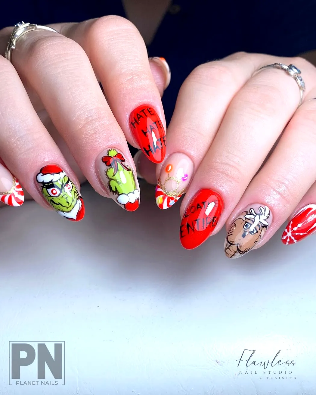 Charming Grinch Nails in Festive Red with Playful Shapes and Whimsical Holiday Art