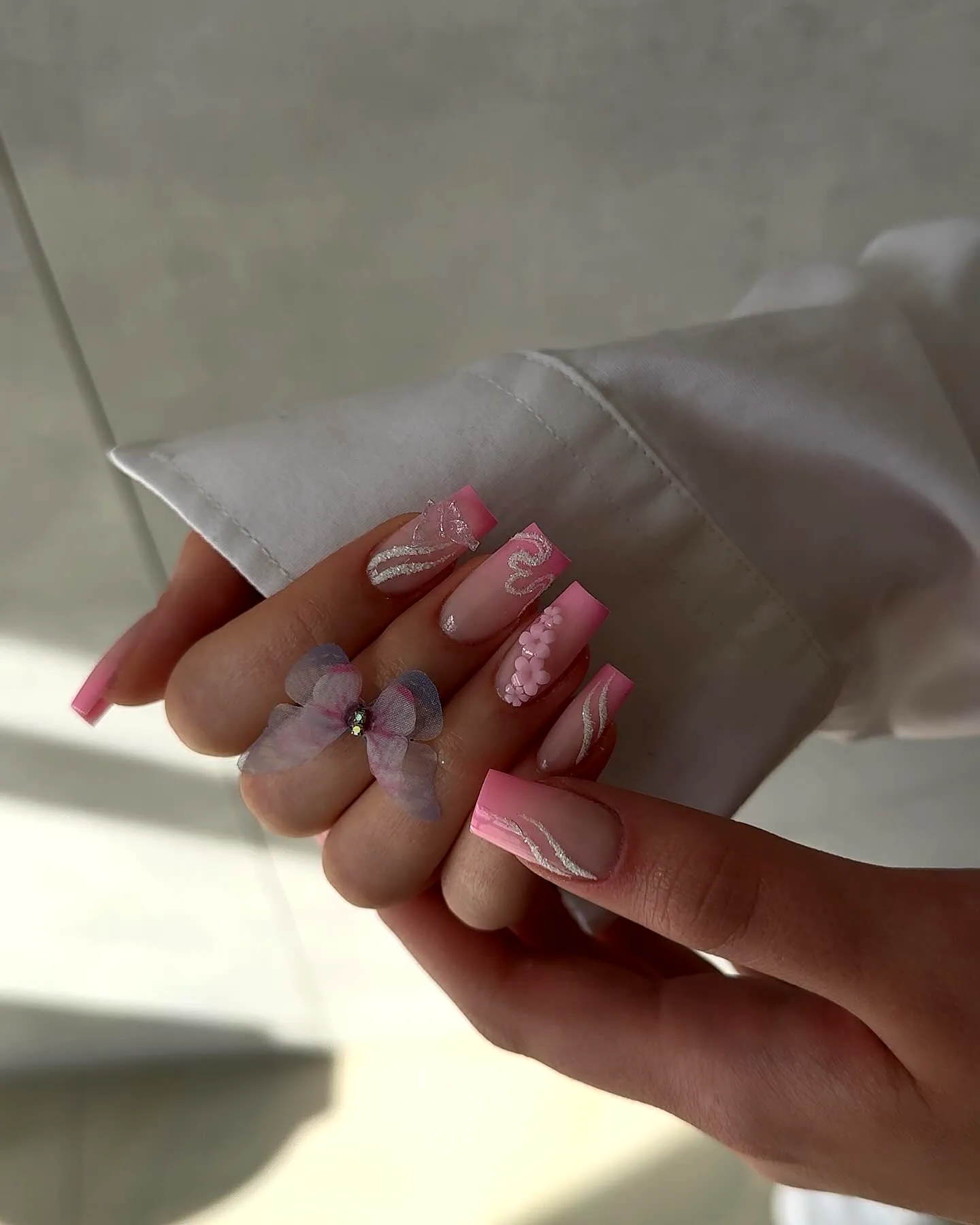 Charming long squared fall ombre nails with colorful butterfly and floral designs in soft pink