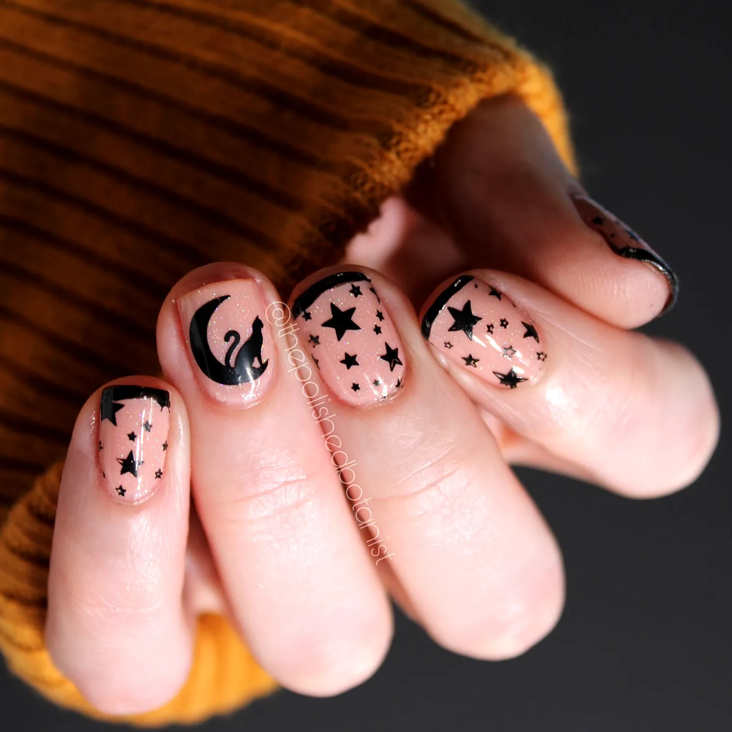 Charming Rounded Black Cat Nails with Pink Base and Whimsical Moon and Star Design