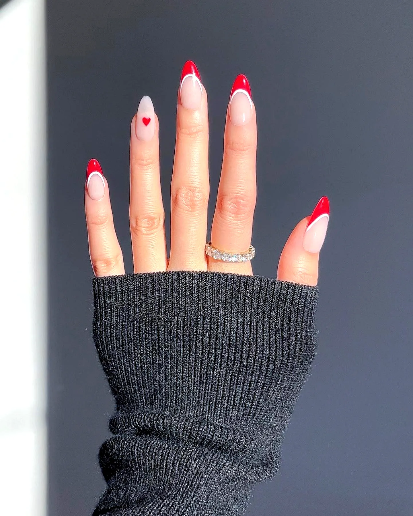 Charming Stiletto Ring Finger Heart Nails with Clear Base and Vibrant Red Tips