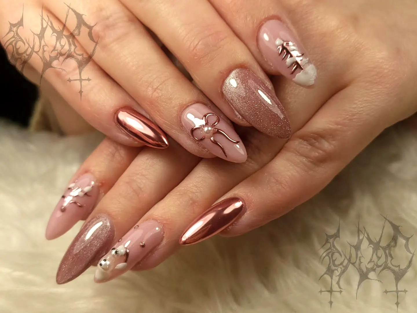 Chic Almond and Stiletto Rose Gold Nails with Intricate Embellishments and Artistic Patterns