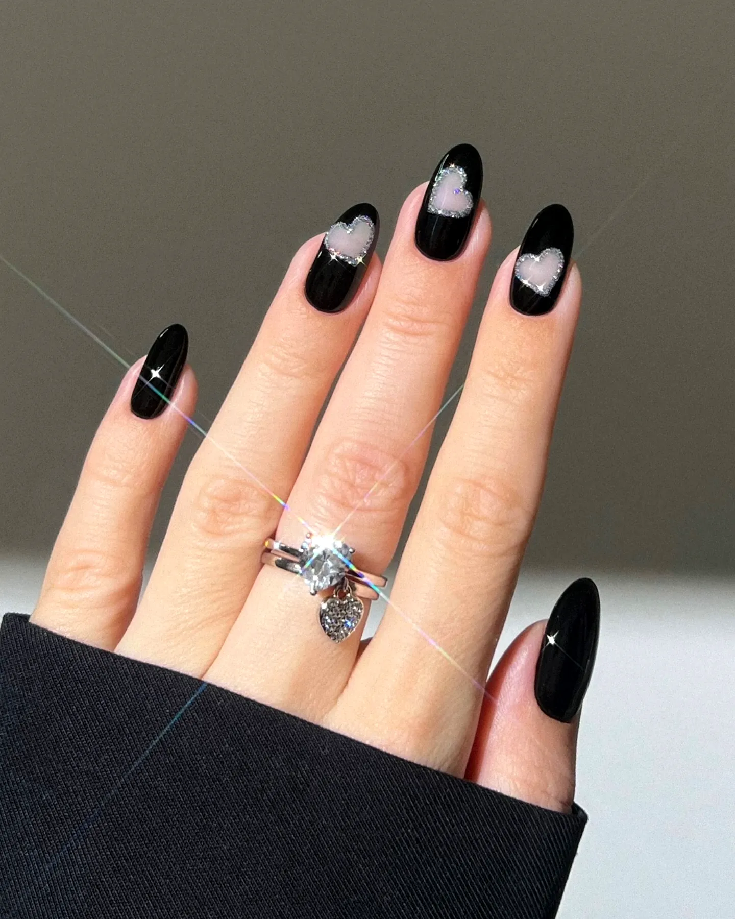 Chic Almond Black Birthday Nails with Negative Space Heart Design and Shimmer