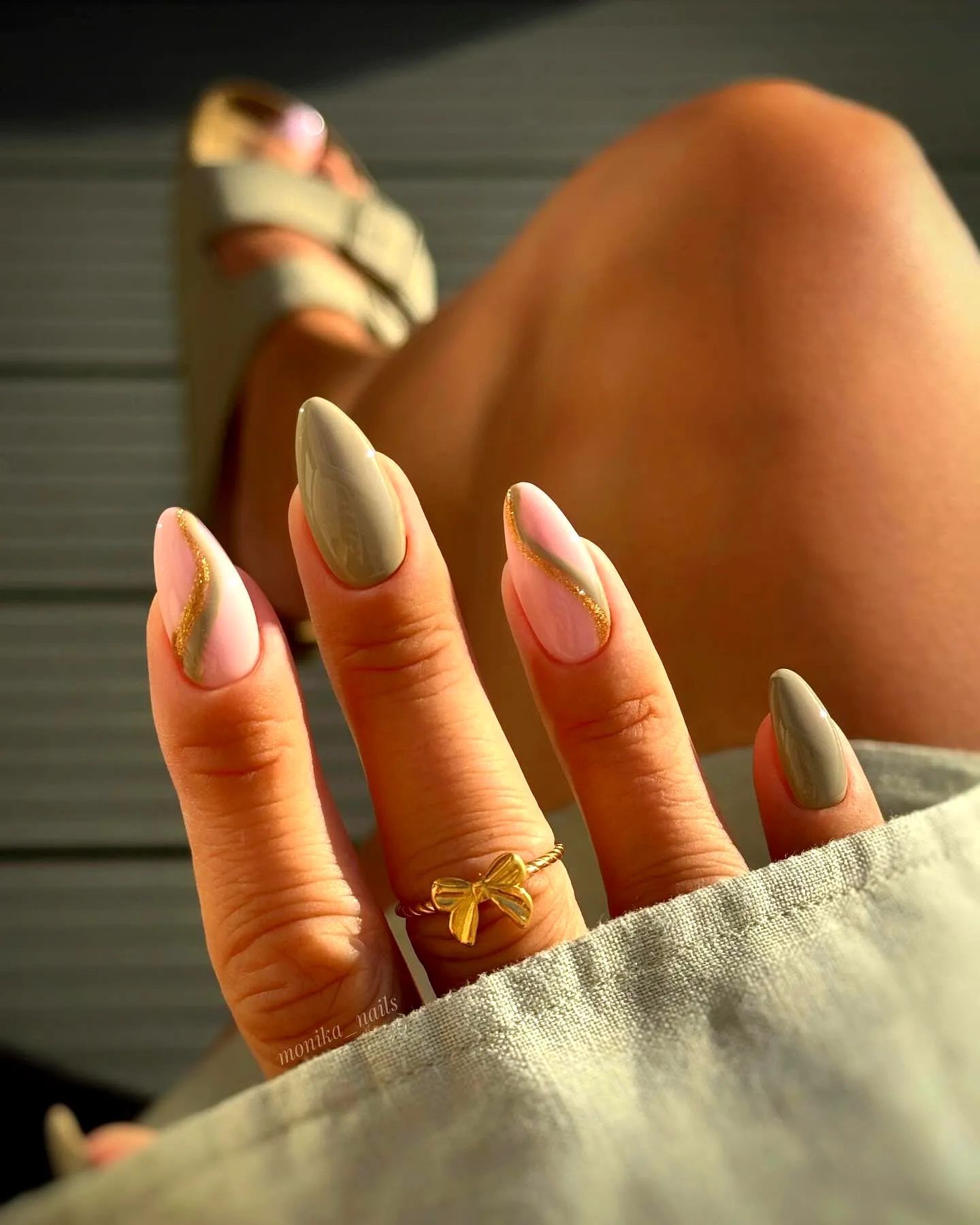 Chic Almond Green Nails with Muted Pink and Gold Stripes for a Minimalist Style