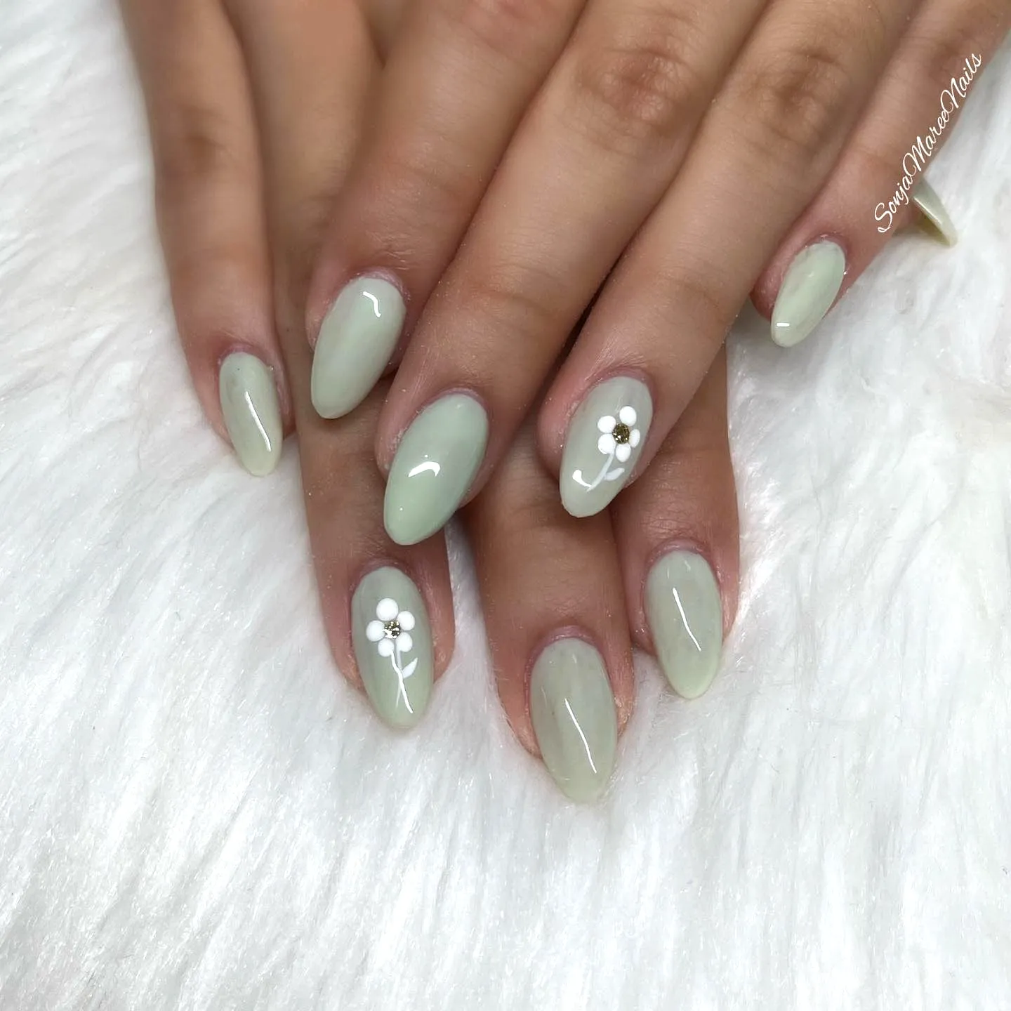 Chic Almond Mint Green Nails with Floral Accents and Glossy Finish