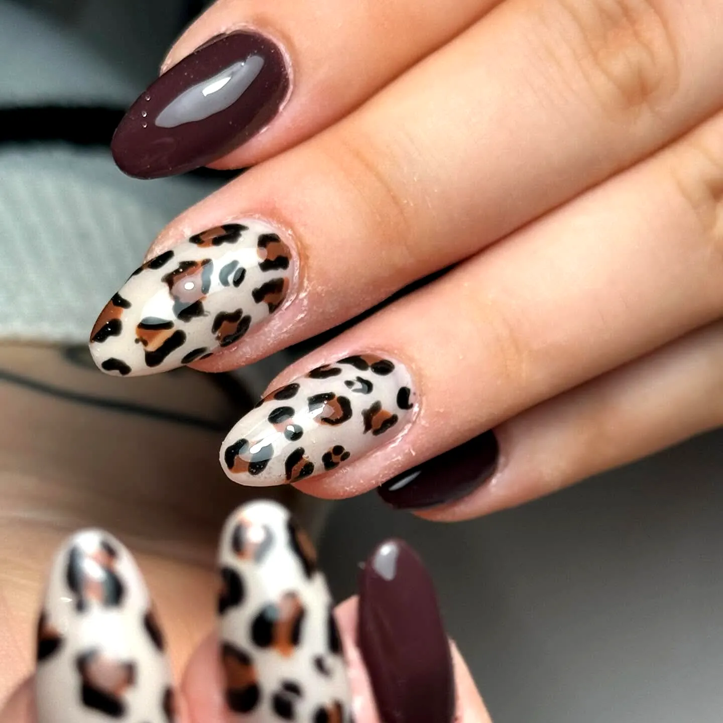 Chic Almond Shaped Animal Print Nails with Glossy Burgundy and Leopard Skin Design