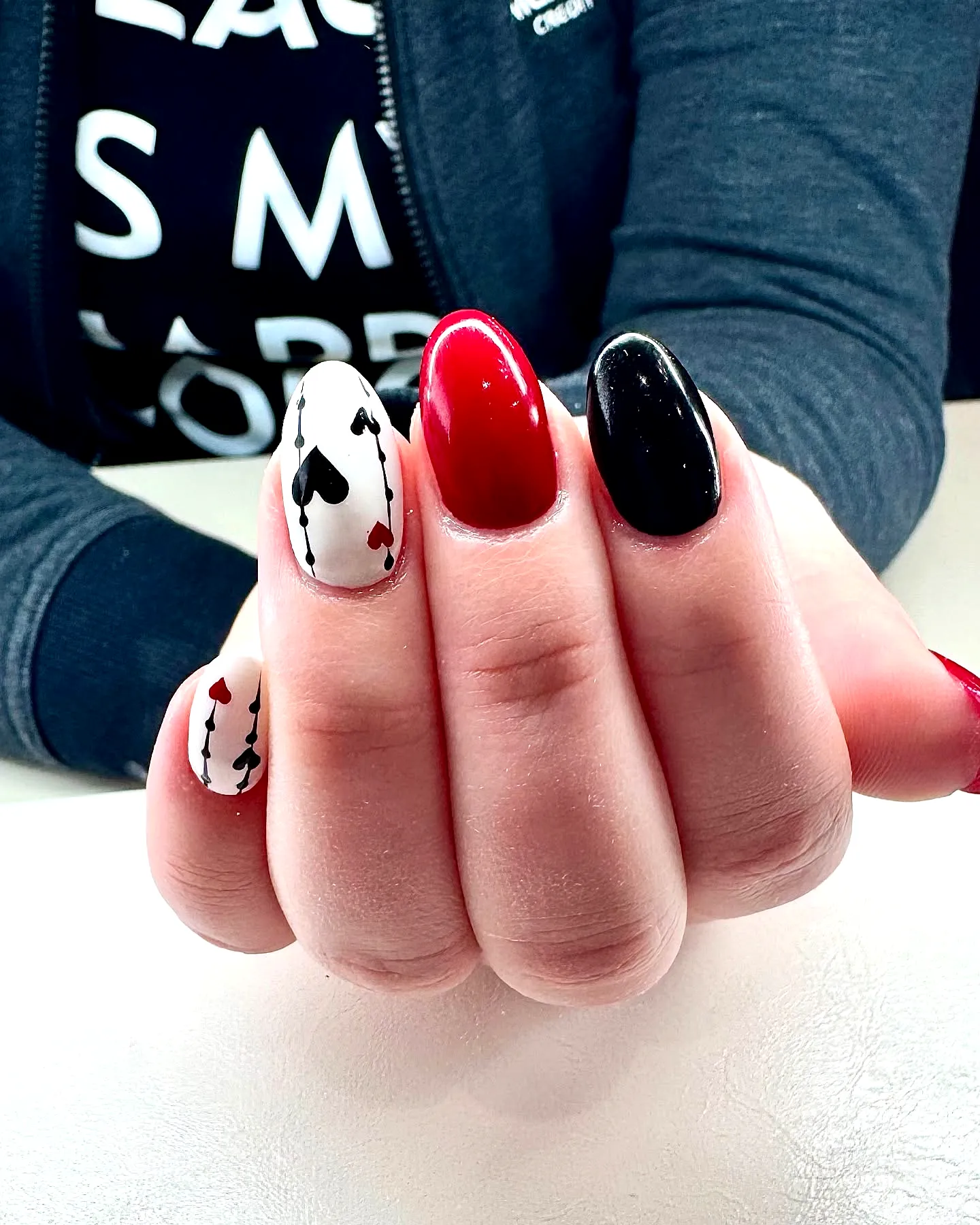 Chic Almond Shaped Black Heart Nails with Playful Card Game Art Elements in Red and White