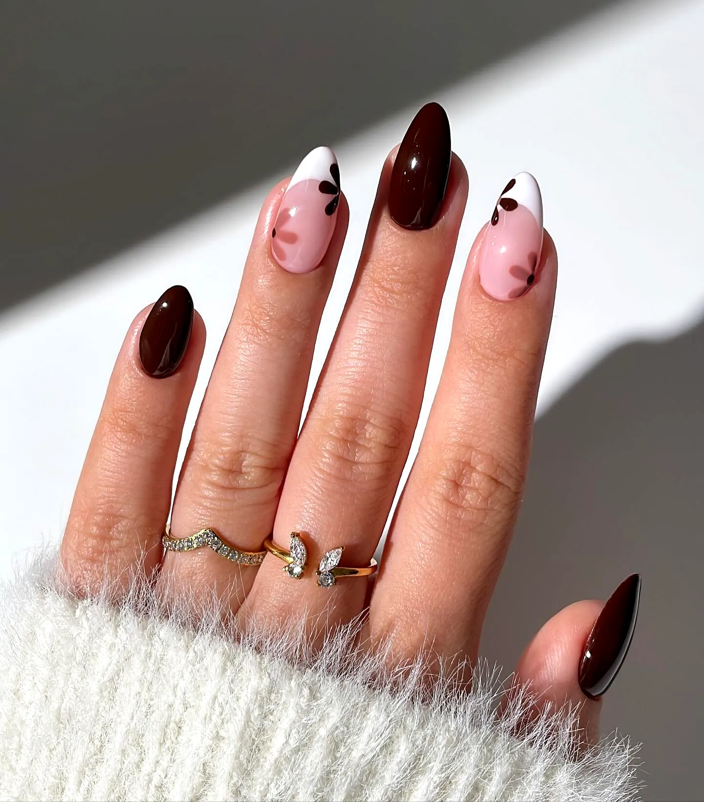 Chic Almond-Shaped Brown Nails with Pink Accents and Leaf Patterns