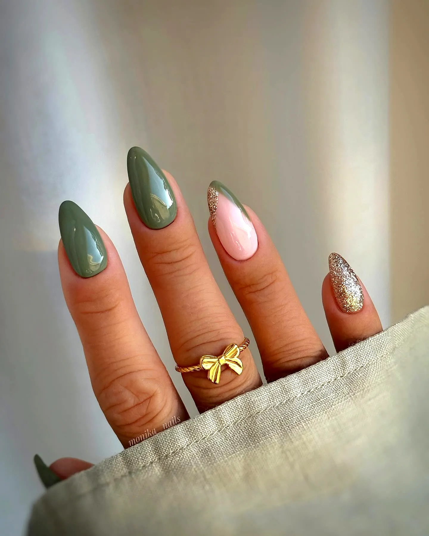 Chic Almond-Shaped Green Nails with Elegant Gold Accent and Glossy Finish