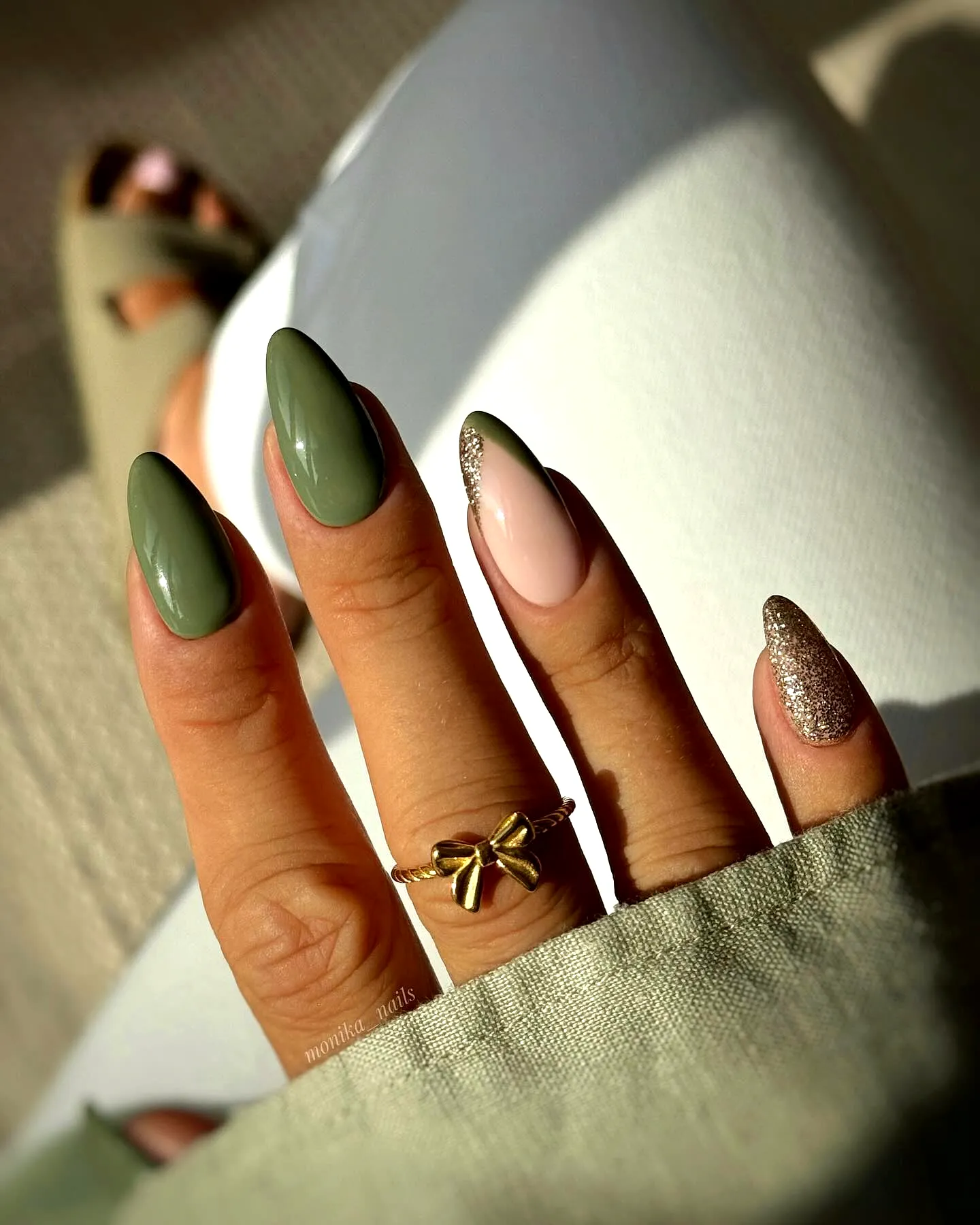 Chic Almond Shaped Green Nails with Olive Green and Soft Pink Design and Glamorous Gold Glitter