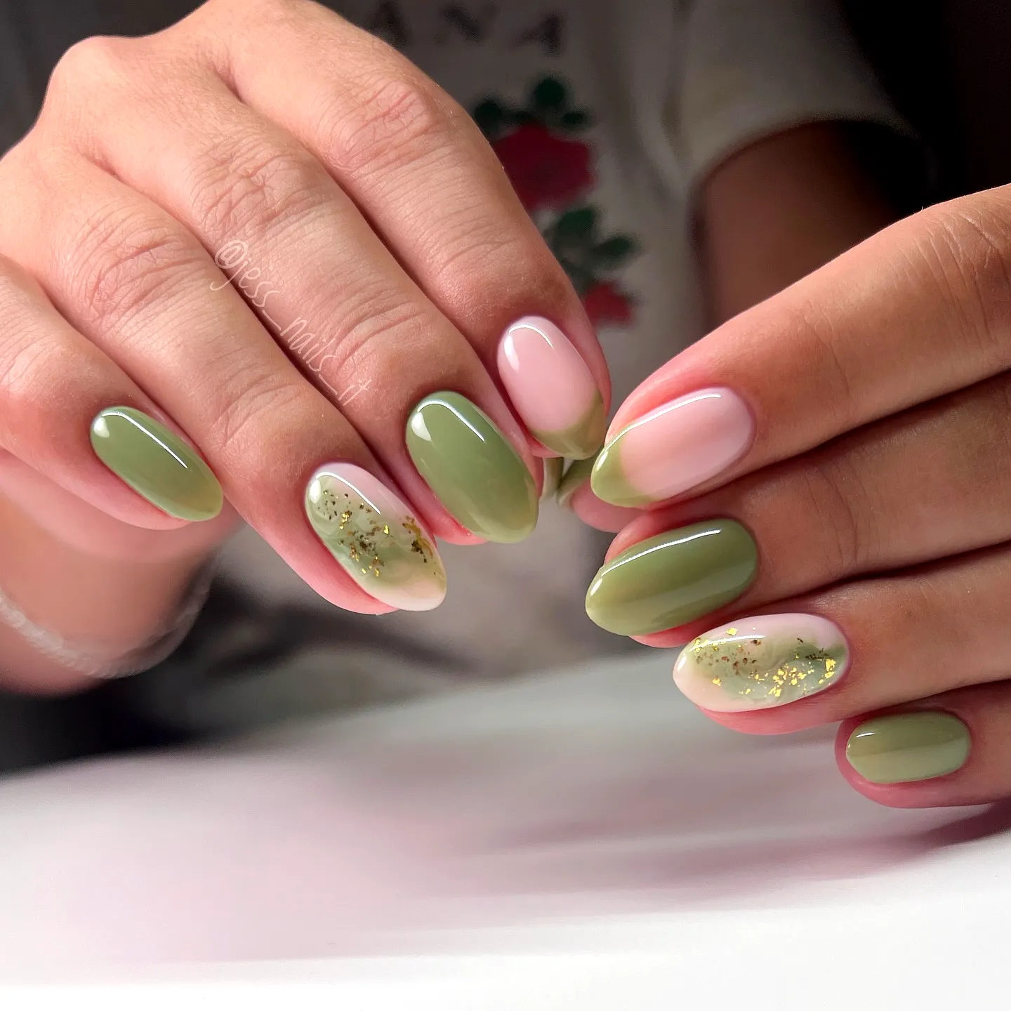 Chic Almond Shaped Green Nails with Pale Pink Gradient and Gold Glitter Accents