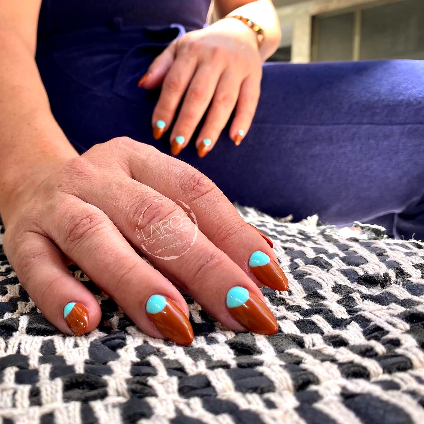 Chic Almond-Shaped Half-Moon Nails in Warm Brown and Vibrant Turquoise