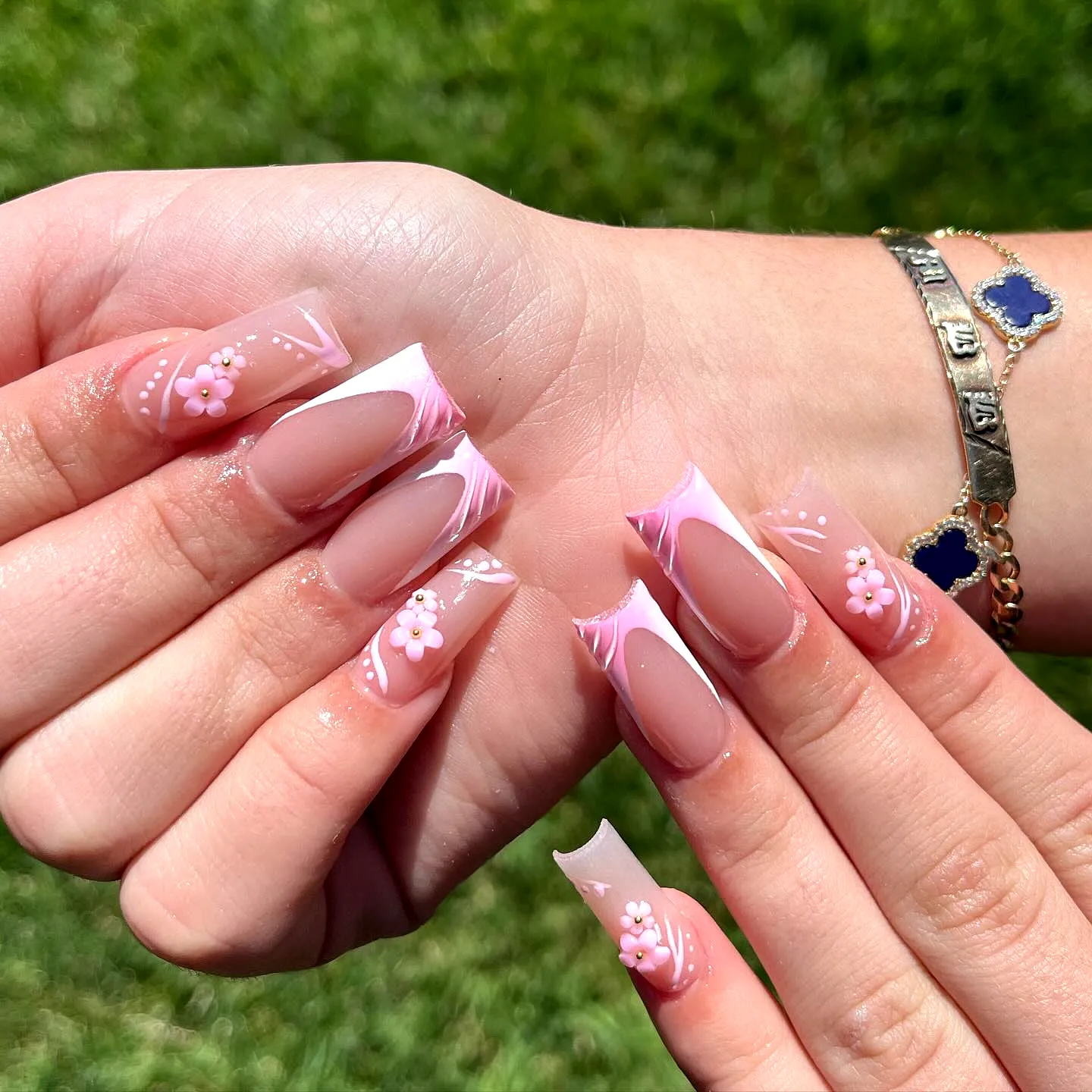 Chic Almond-Shaped Pink Birthday Nails with Floral Accents and Elegant Swirls