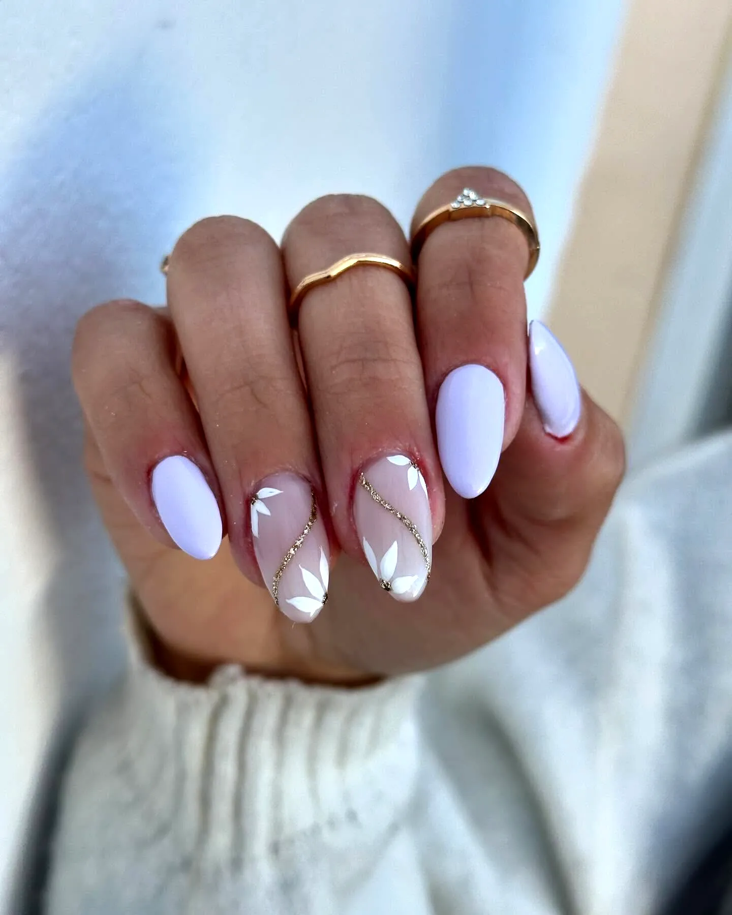 Chic almond shaped purple spring nails with lavender nude color and elegant leaf pattern
