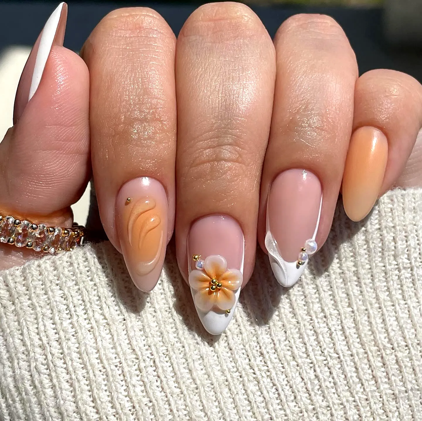 Chic Almond Spring Nails with Peach and Nude Palette Floral Design and Gold Accents