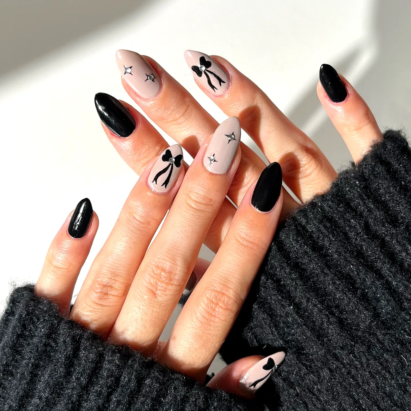 Chic Black Birthday Nails with Pointed and Almond Shapes Featuring Bows and Stars