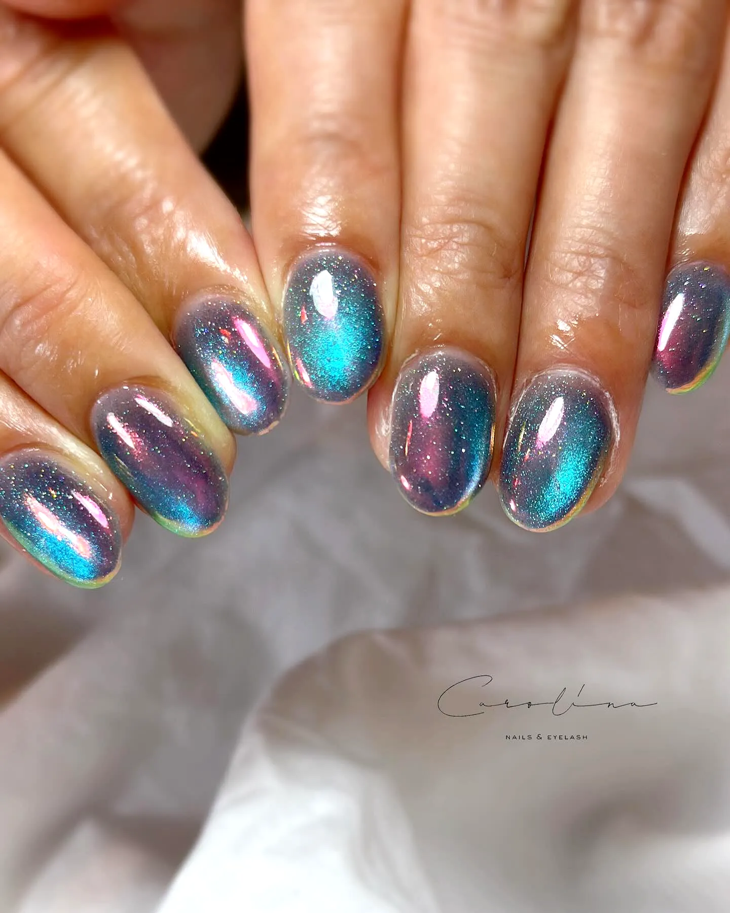 Chic Iridescent Aurora Nails in Elongated Oval Shape with Teal to Pinkish Purple Gradient and Sparkling Holographic Design