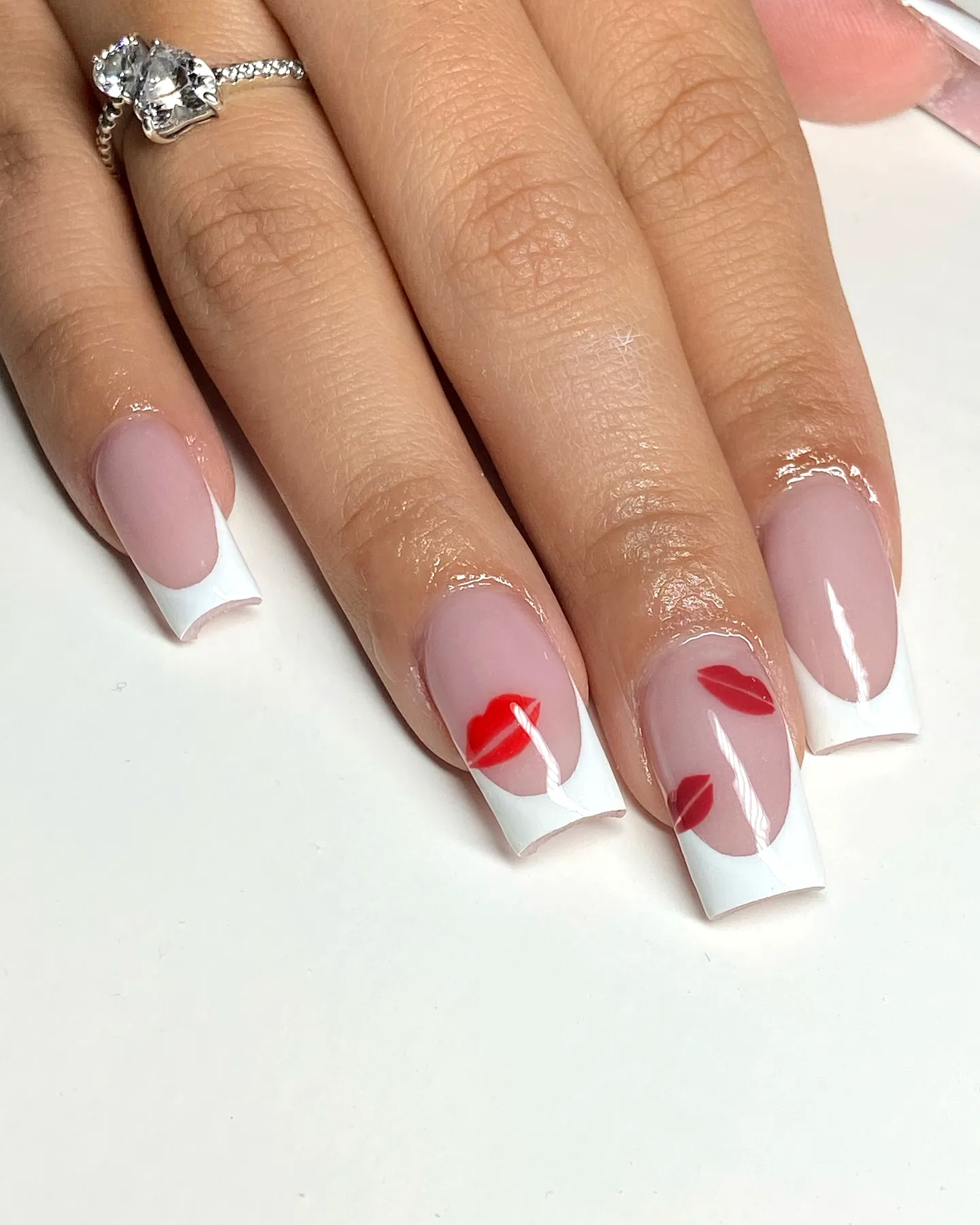 Chic Nude French Tip Ring Finger Heart Nails with Playful Red Lip Prints