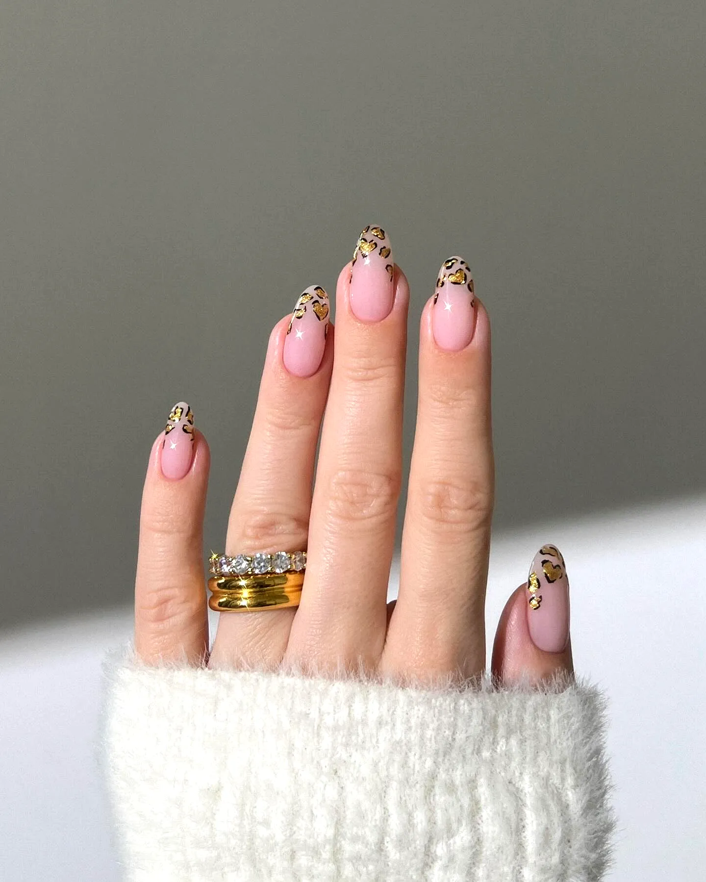 Chic Oval Gold Nails with Soft Pink Base and Leopard Print Tips