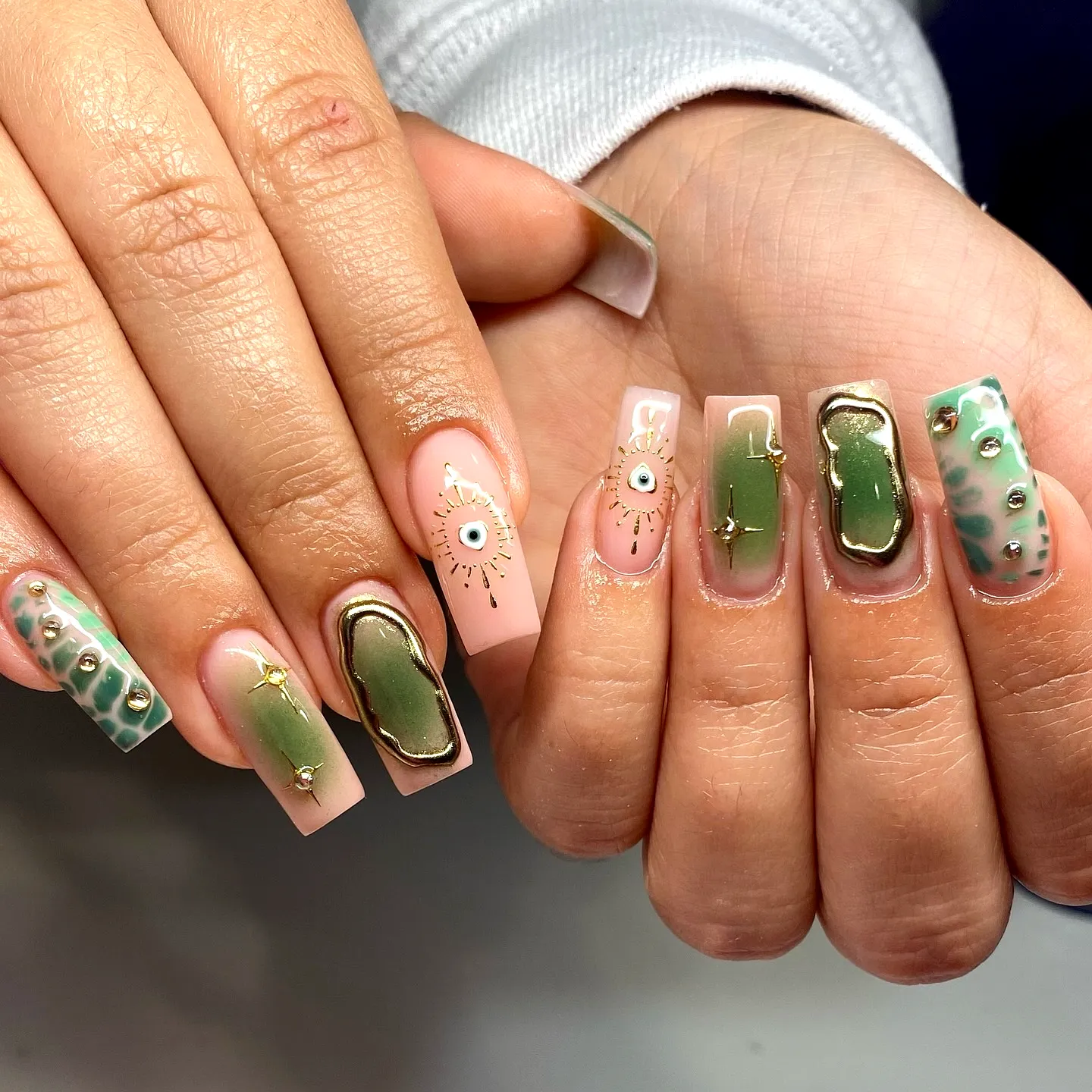 Chic Rectangular Green Nails with Eye-Inspired Art and Marble Accents