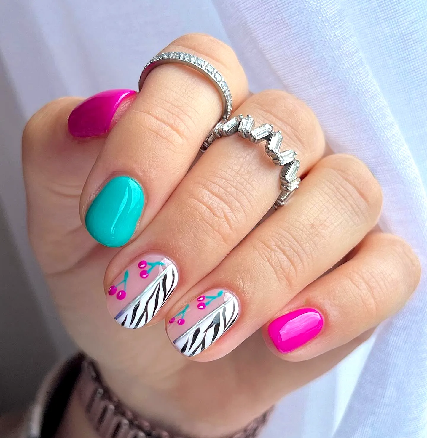Chic Rounded Zebra Print Nails with Vibrant Colors and Floral Accents