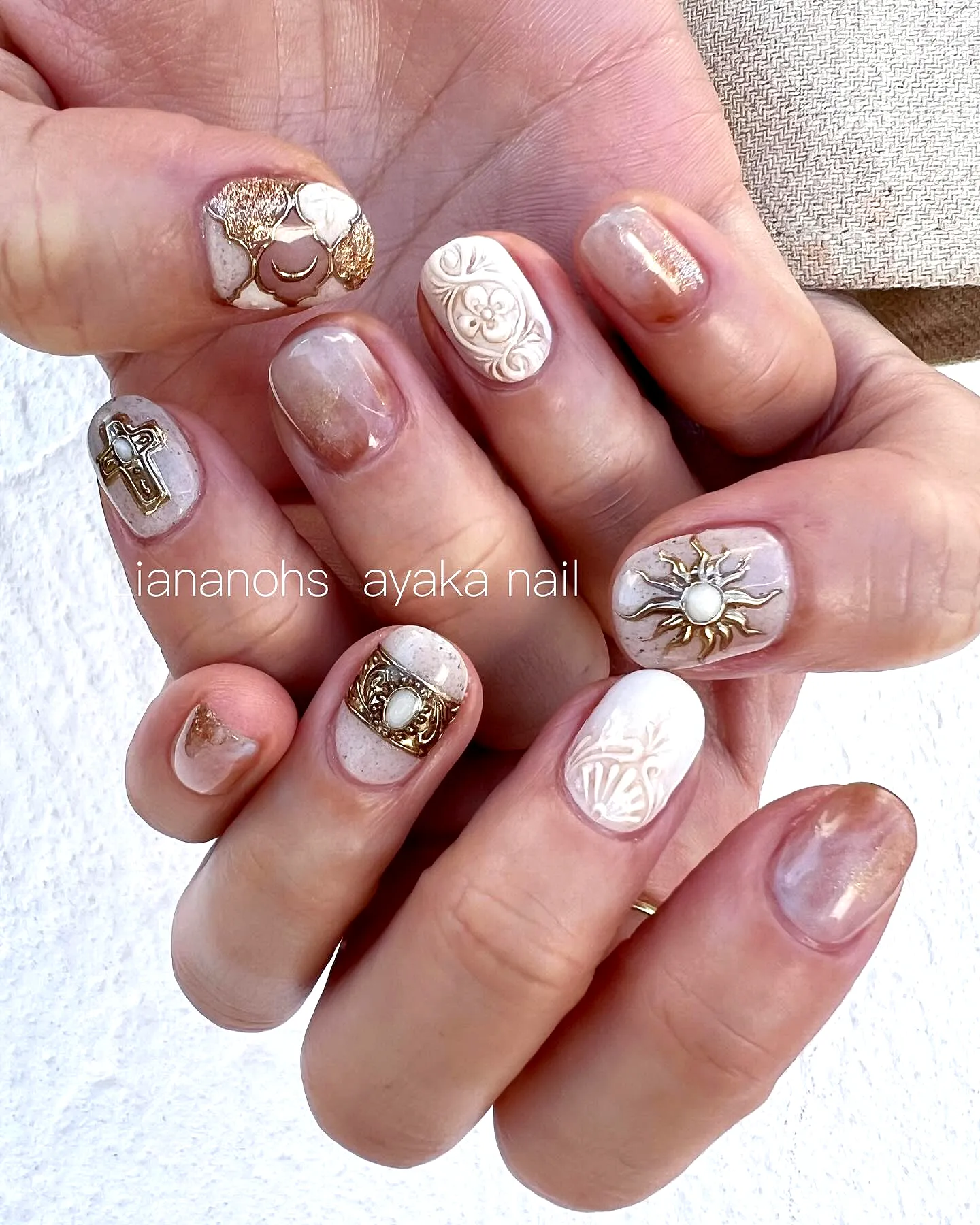 Chic Short Rounded Gothic Easter Nails with Gold Embellishments and Textured Floral Patterns in White and Beige