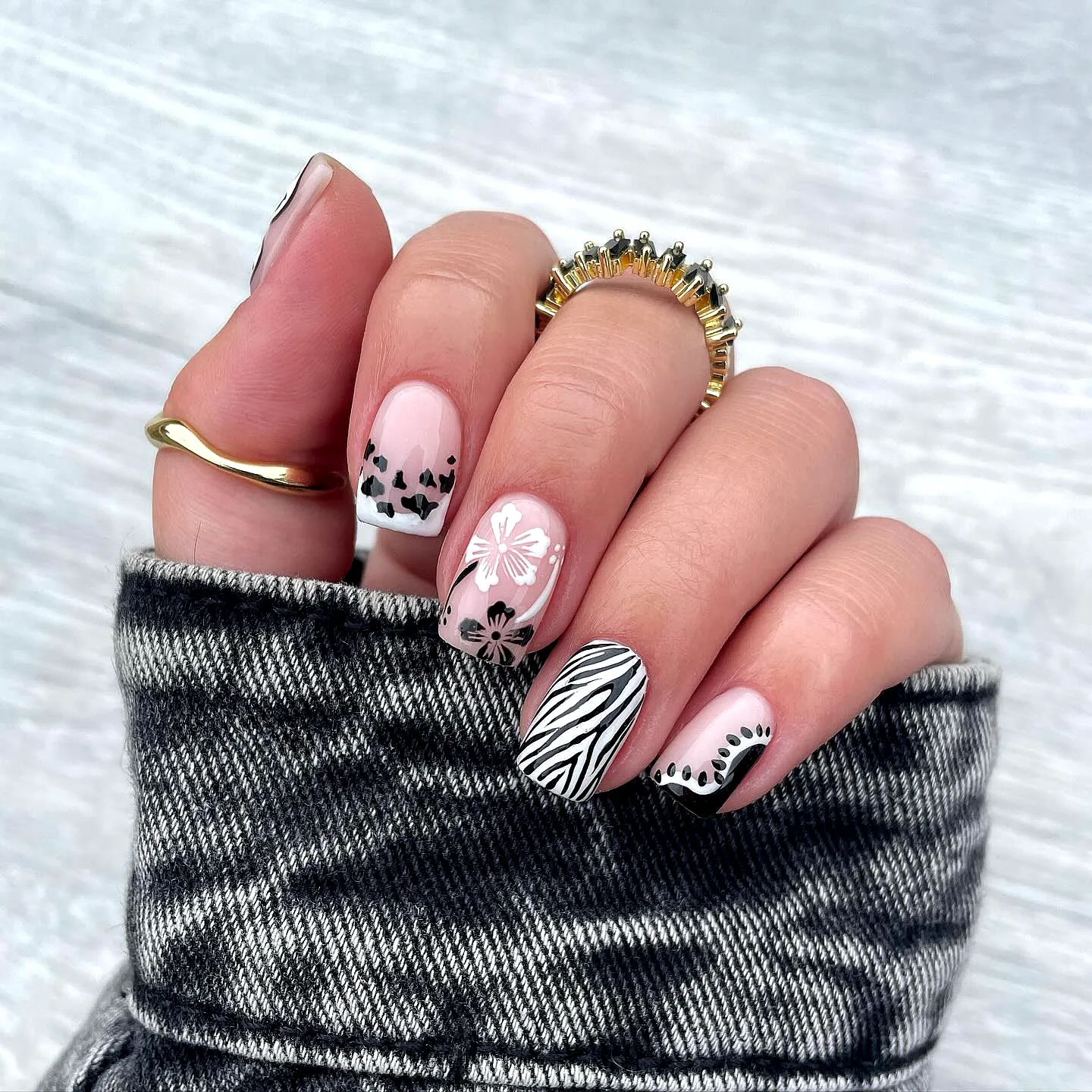 Chic squoval black and white polka dot nails with pastel pink accents and modern patterns